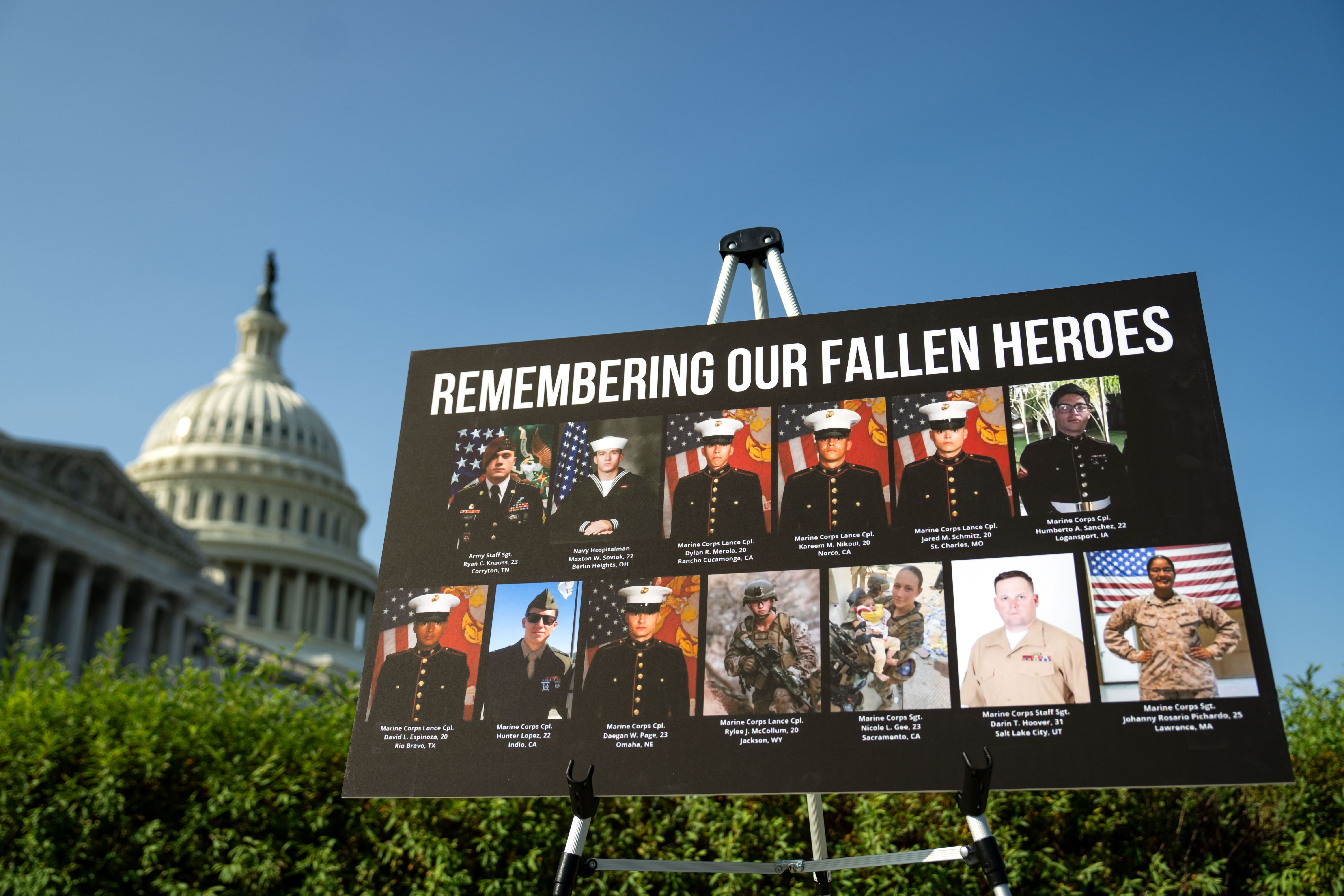 A sign displaying the 13 U.S. service members killed in the Abbey Gate attack outside Kabul's airport is shown during a September 2024 news conference in Washington, DC.