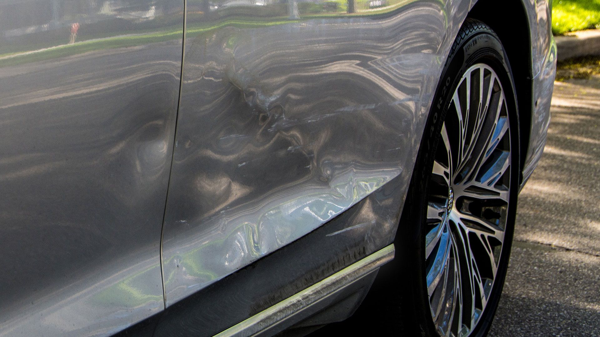 Image of a dent in the side of an Audi A8