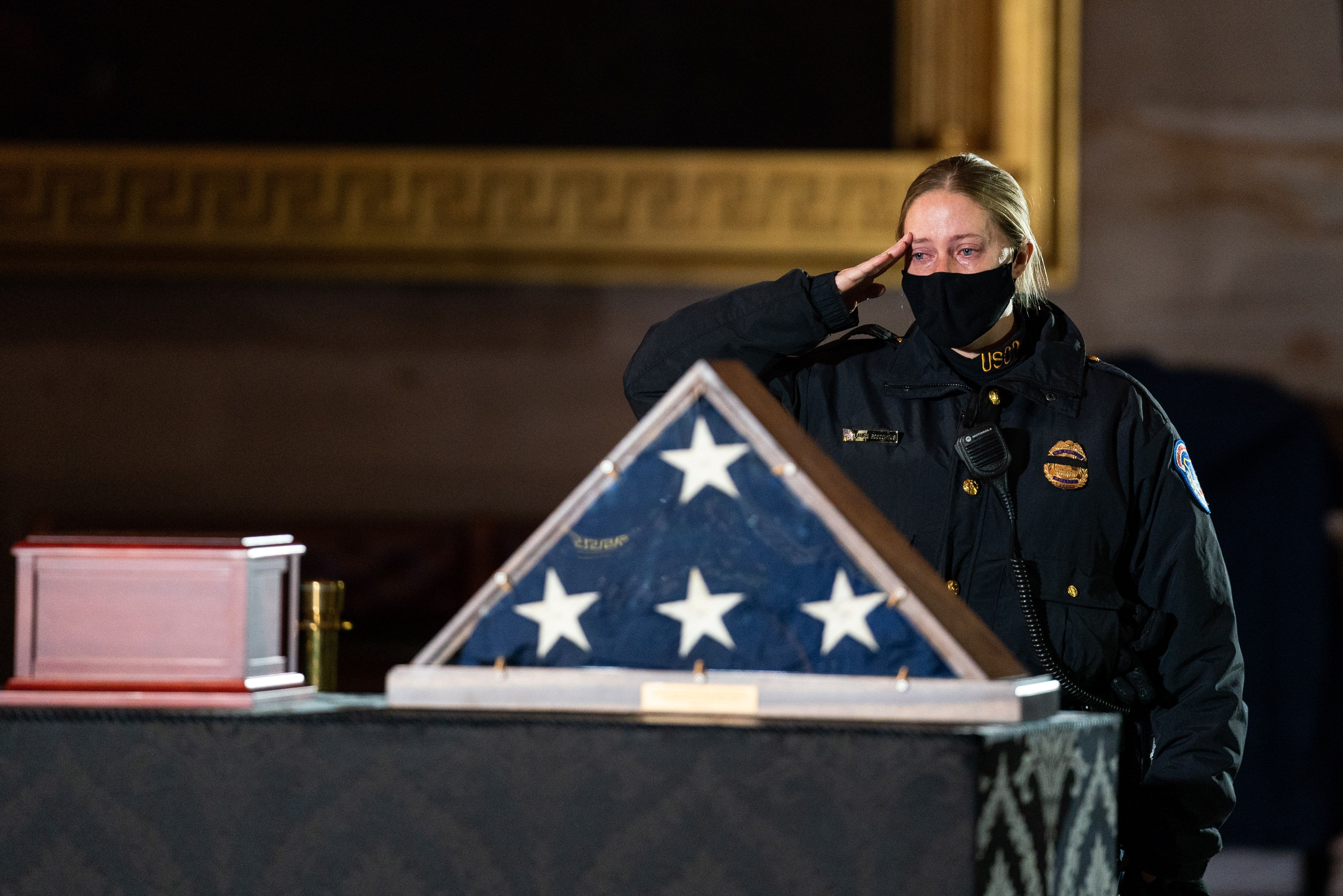 A USCP officer salutes Sicknick. Photo: Anna Moneymaker - Pool/Getty Images