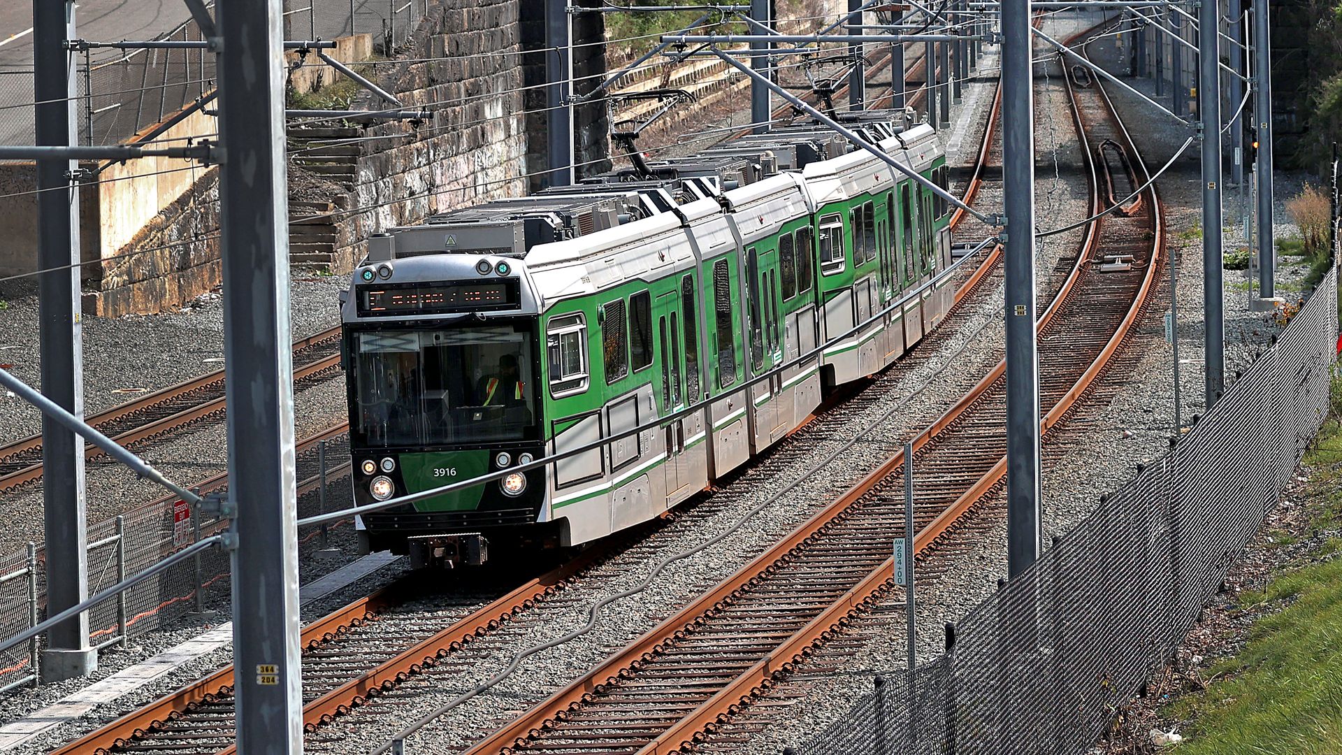 A train on the Green Line Extension travels on the tracks.