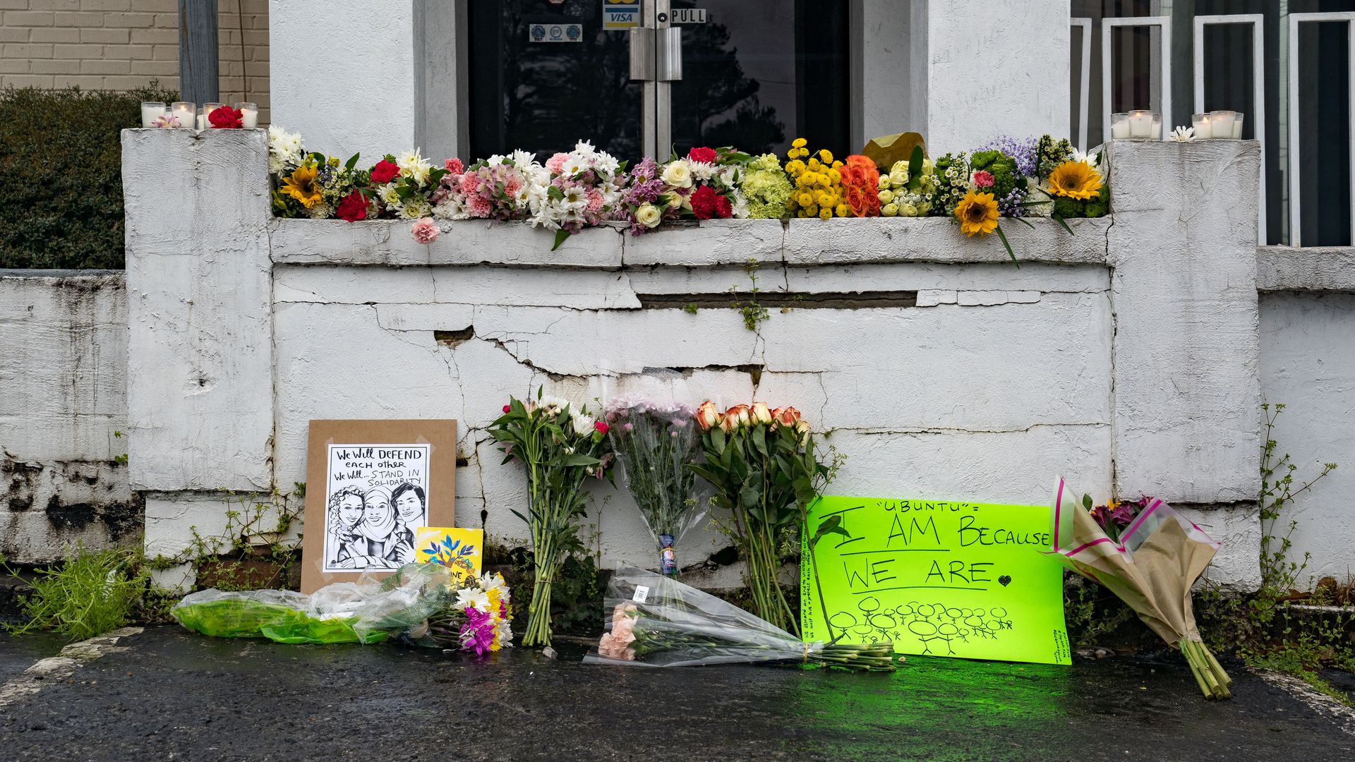 Photo of flowers adorning the entrance to a building and signs 