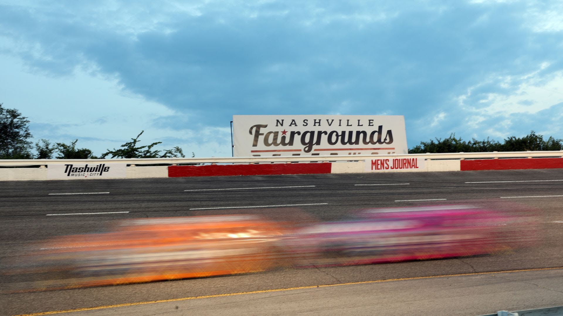 Blurred drivers race at the Nashville fairgrounds racetrack in 2021.