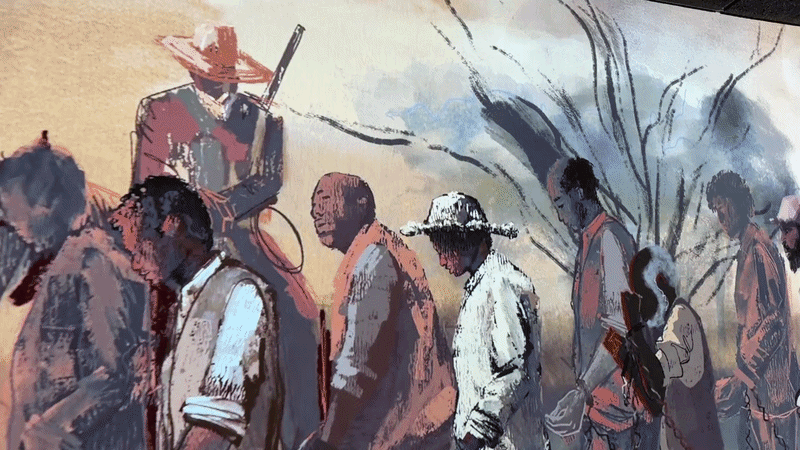 a video showing an animated illustratio of Black men, women and children chained and walking