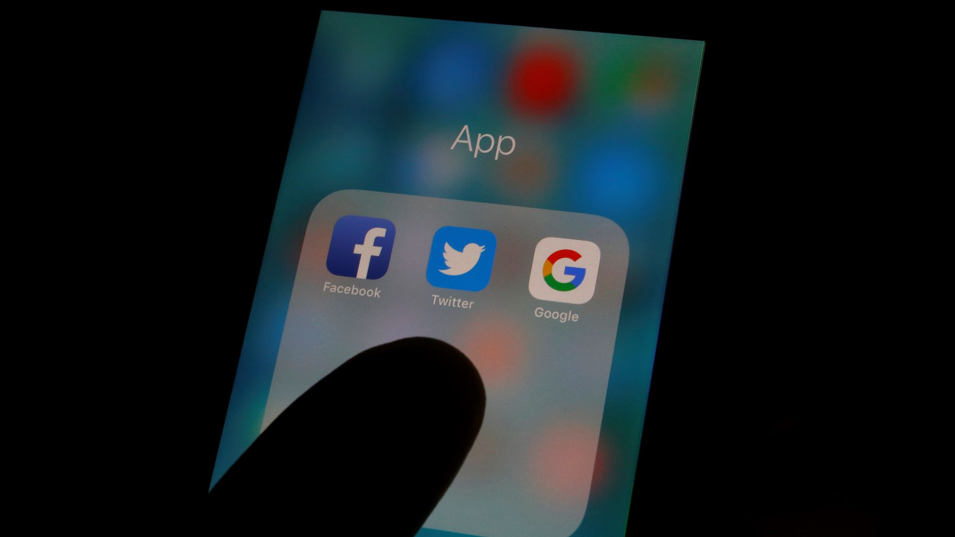 Facebook, Twitter, and Google app icons on a smartphone screen