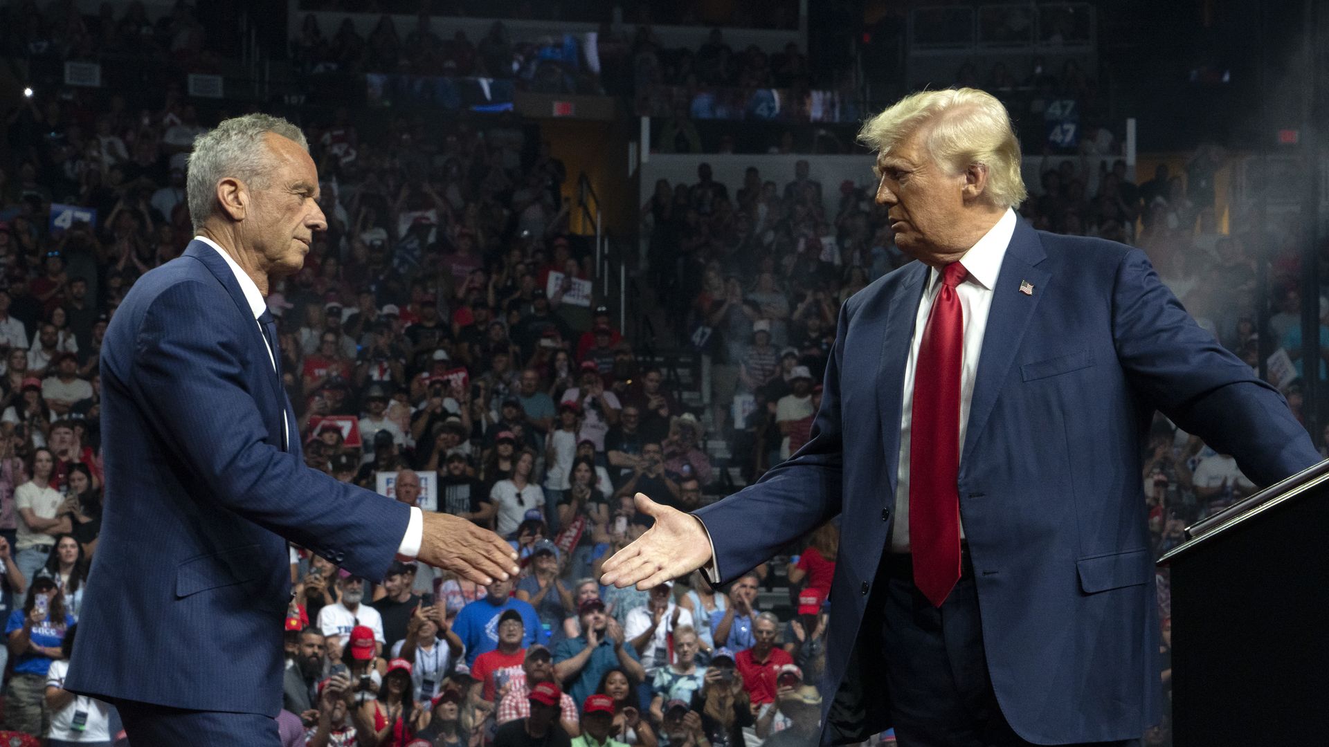  Former Republican presidential candidate Robert F. Kennedy Jr. and Republican presidential nominee, former U.S. President Donald Trump shake hands during a campaign rally at Desert Diamond Arena on August 23, 2024 in Glendale, Arizona.