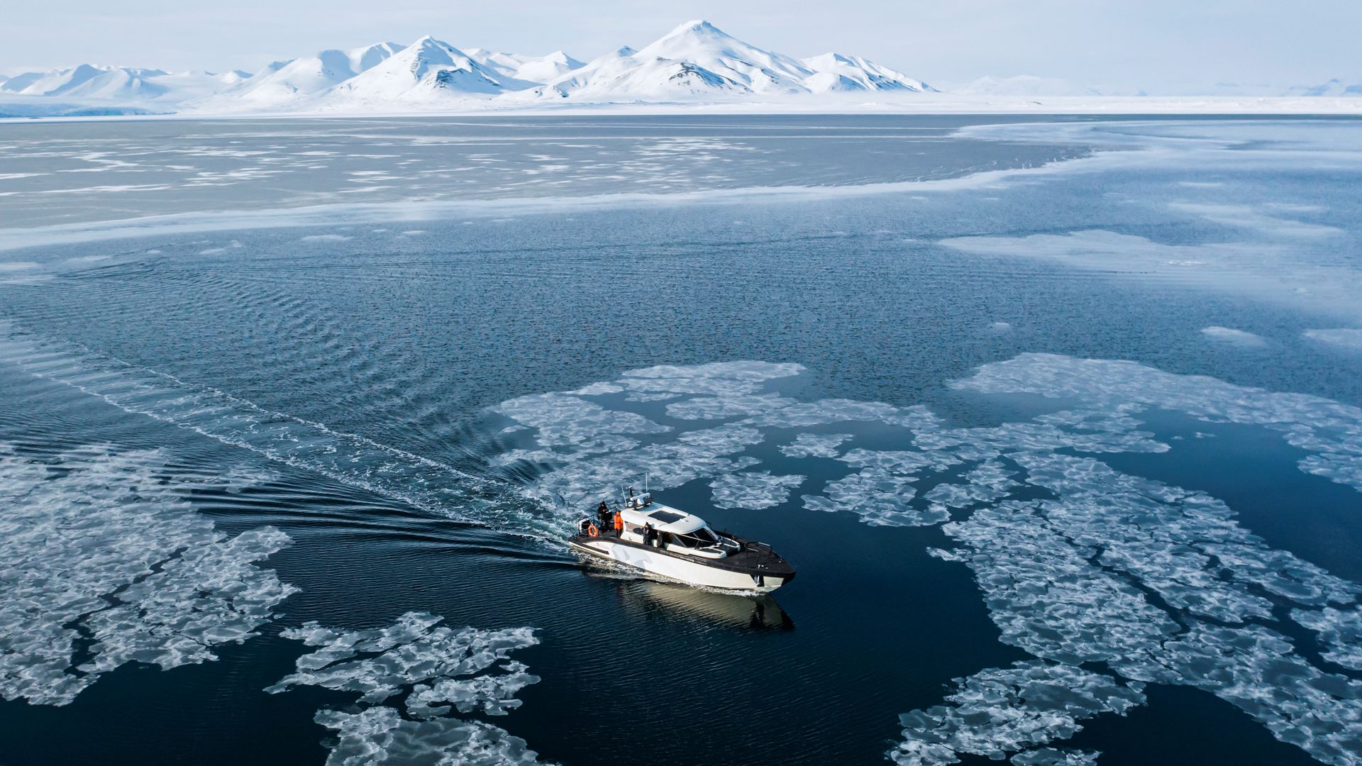 An aerial view image taken on May 3, 2022 showing a tourist boat making its way in the sea ice in the Borebukta Bay, located at the northwestern side of Isfjorden, in Svalbard Archipelago, northern Norway. 