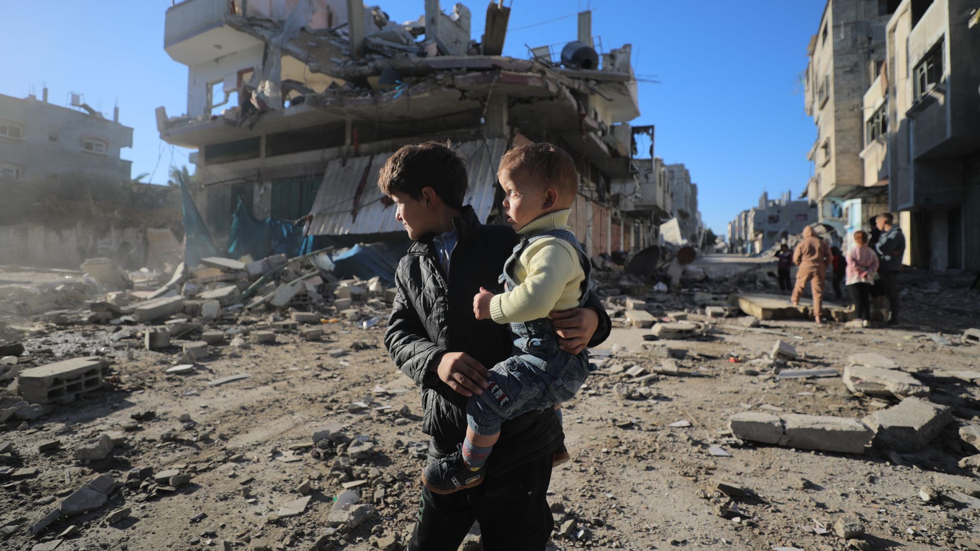 Palestinians in rubble