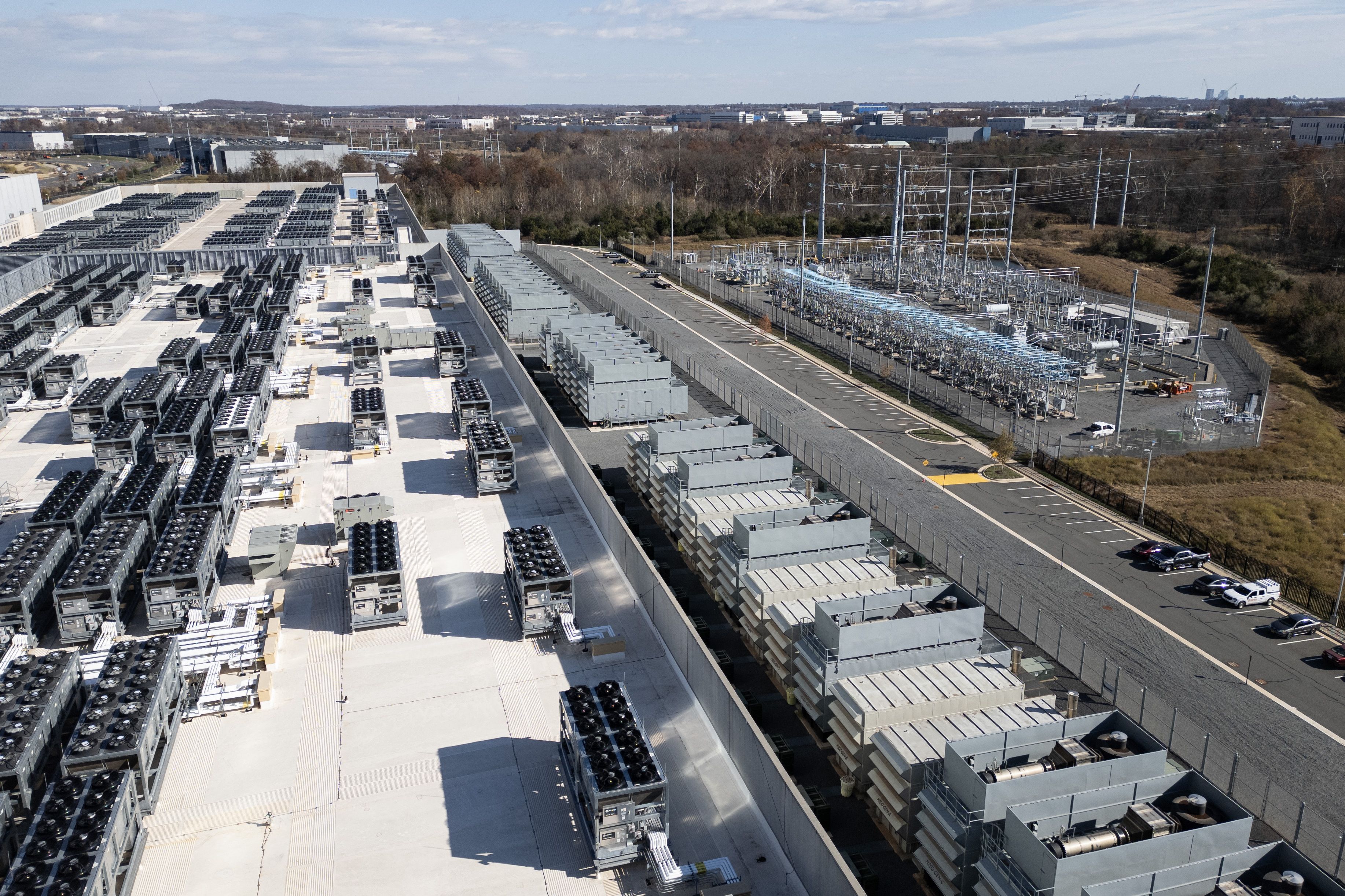 An aerial view of rooftop cooling fans and generators at a Digital Realty data center beside a power substation in Ashburn, Virginia.