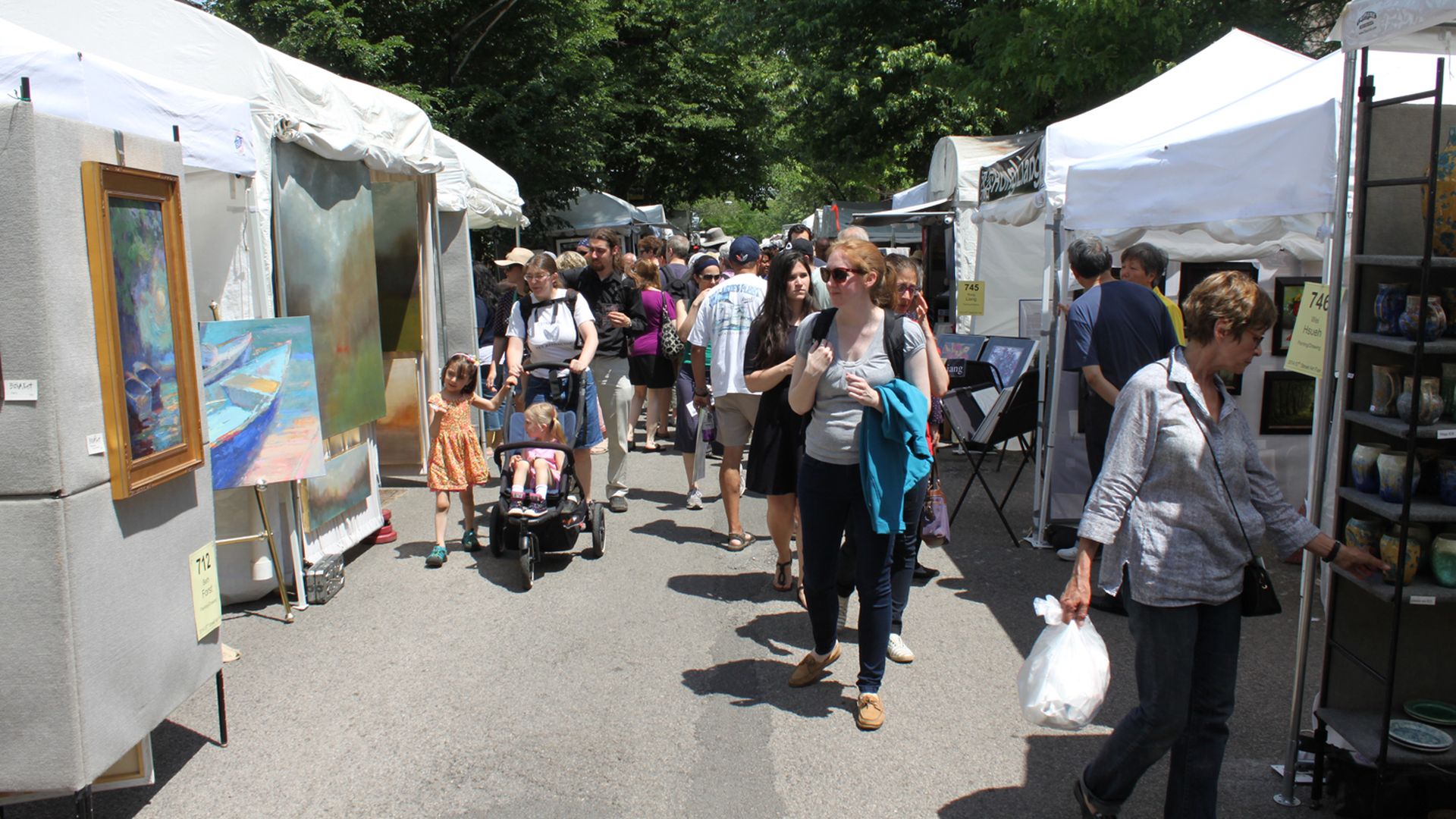 Guests browsing paintings at the 57th Street Art Fair.