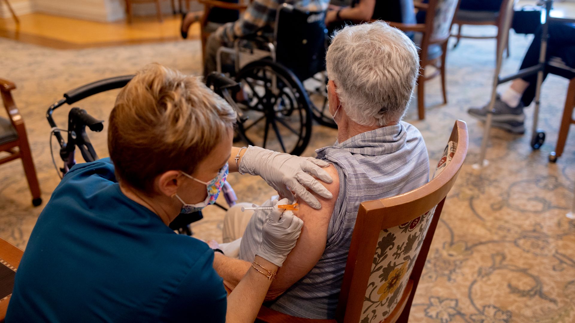 A healthcare worker administers a third dose of the Pfizer-BioNTech Covid-19 vaccine at a senior living facility in Worcester, Pennsylvania, U.S., on Wednesday, Aug. 25, 2021.