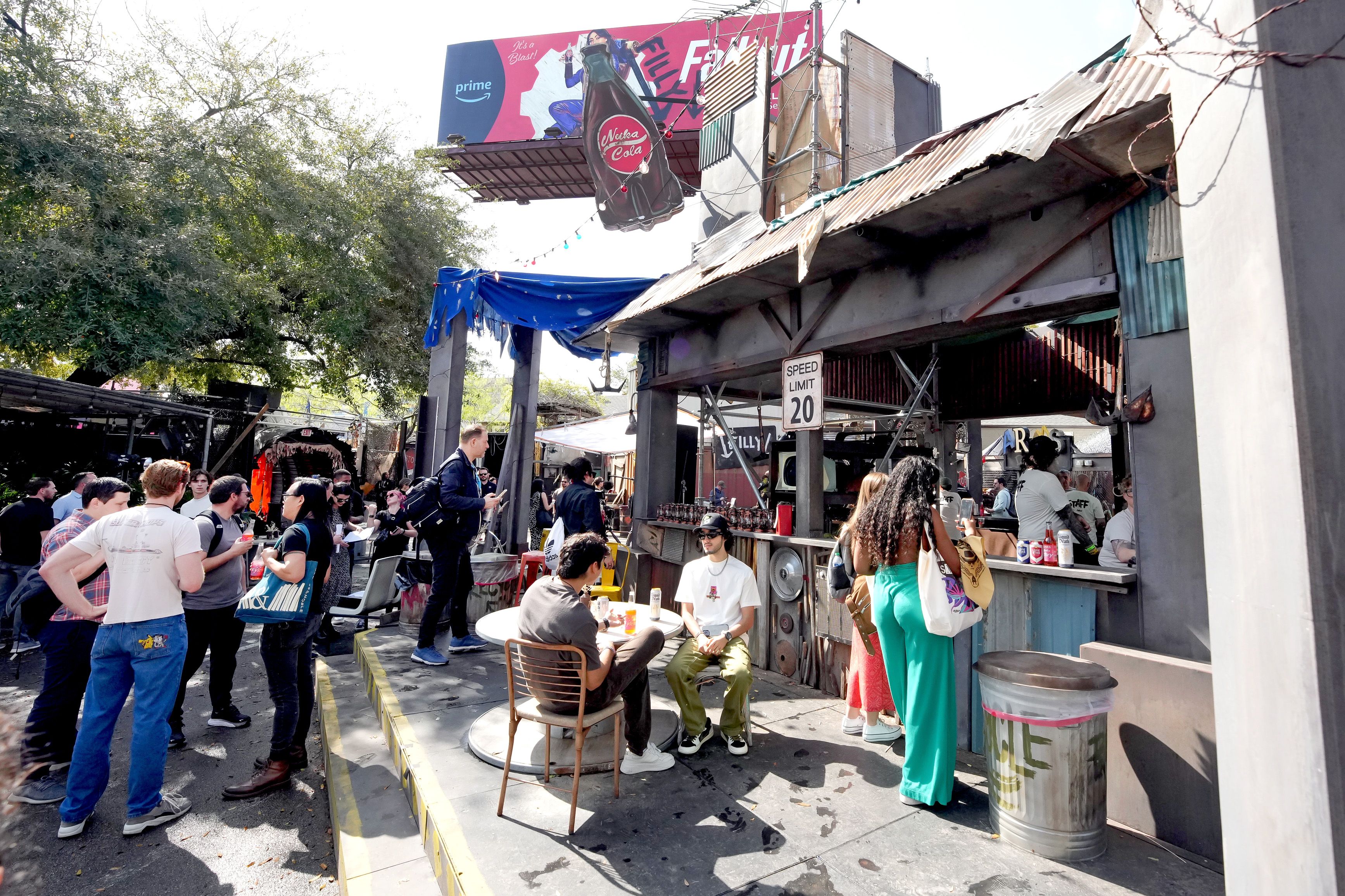A photo of a crowd of people around a hotel patio.