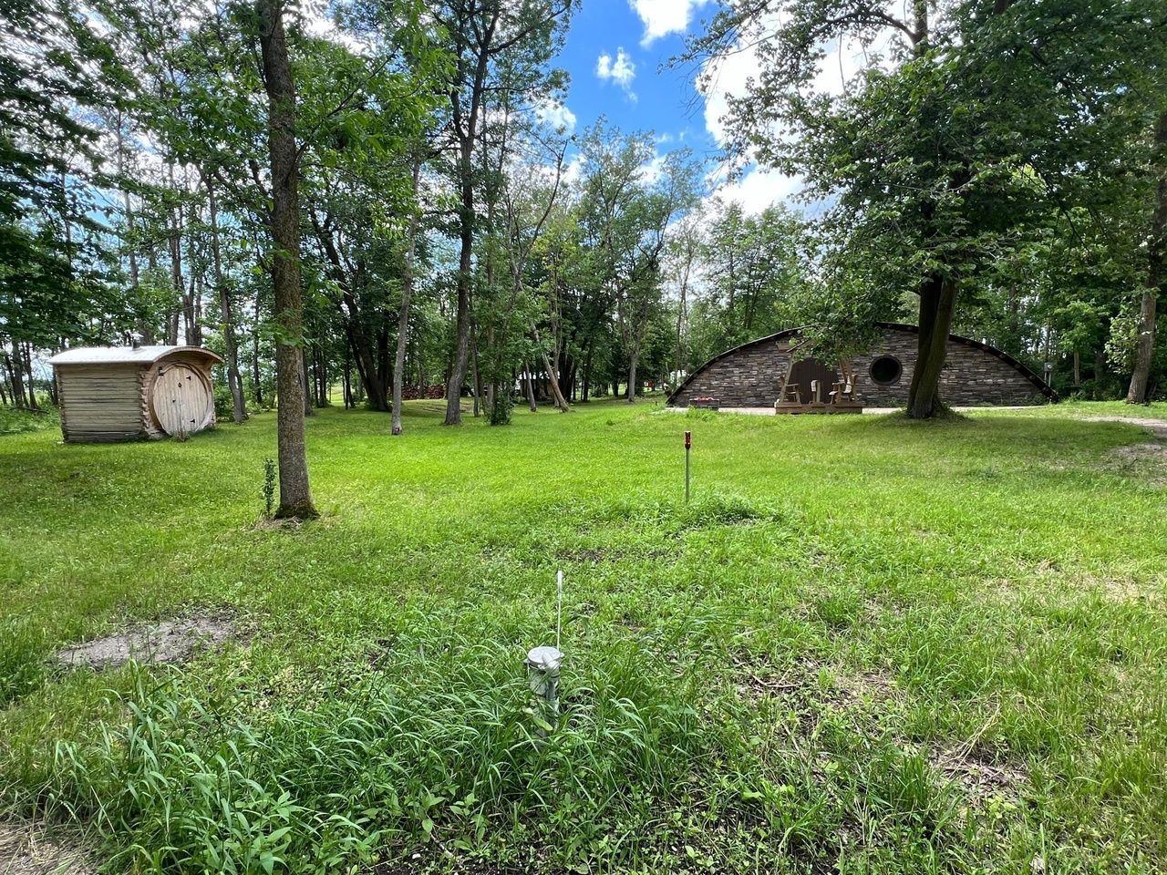 A property with a sauna, half-circle house and forest views.