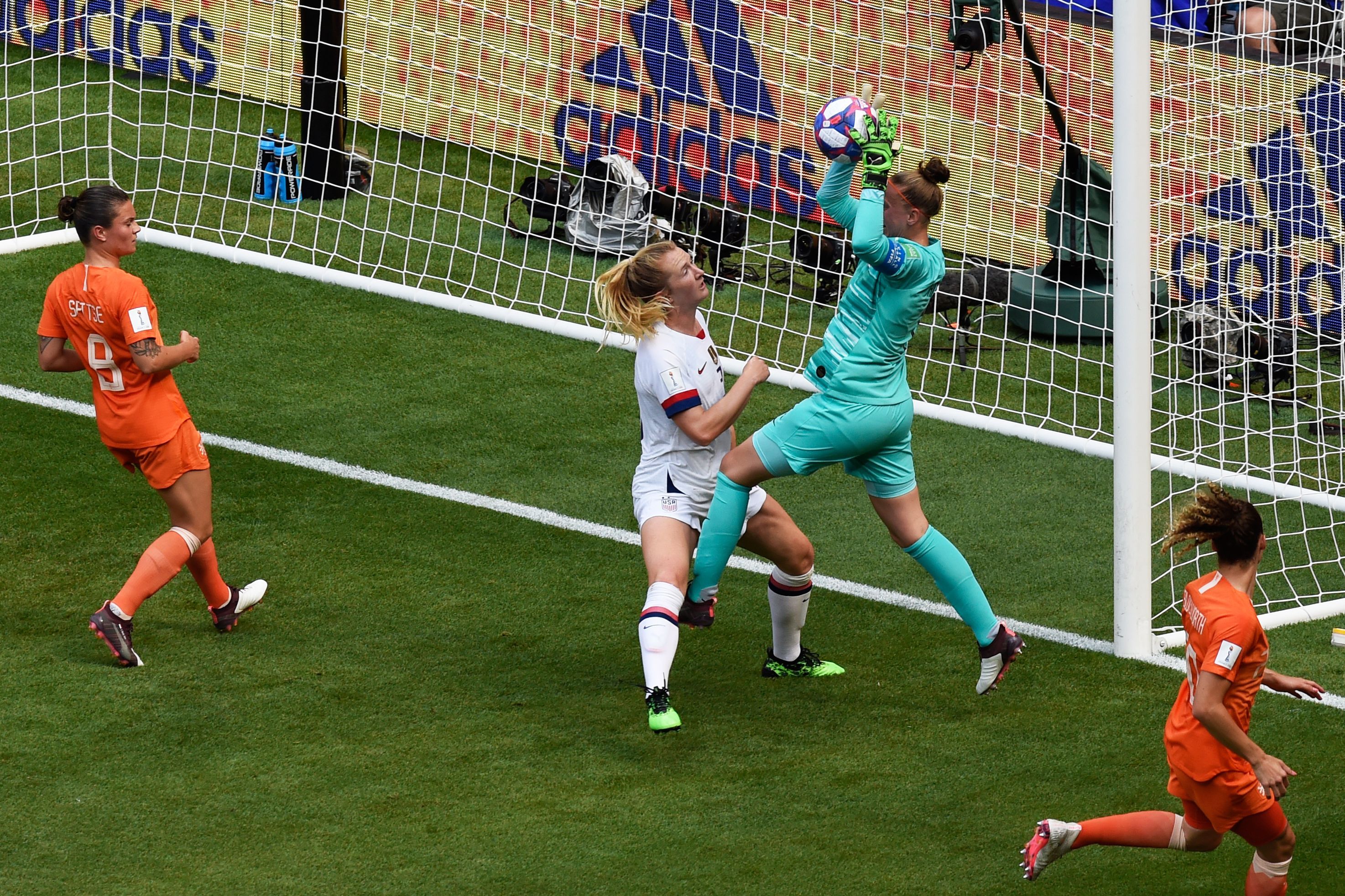 Netherlands' goalkeeper Sari van Veenendaal gets to the ball before United States' midfielder Sam Mewis the ball during the France 2019 Womens World Cup football final match.