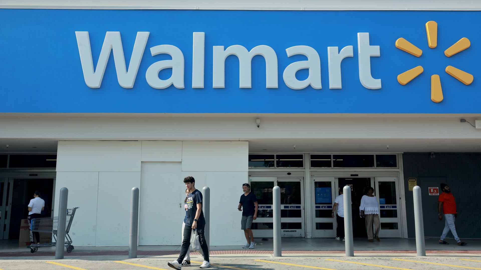 Shoppers walking in and out of a Walmart store