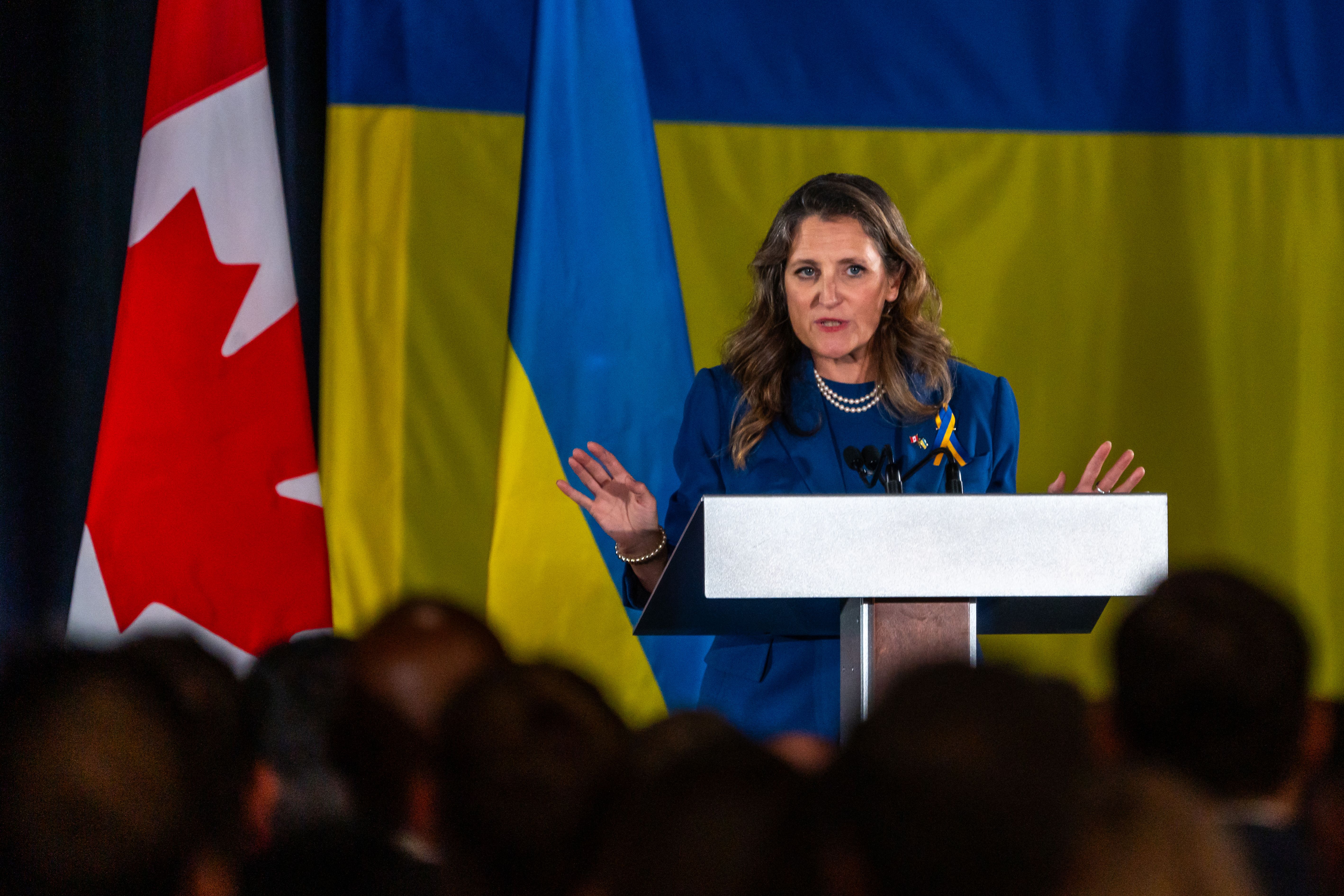 Then-Canadian Deputy Prime Minister Chrystia Freeland in front of the Ukrainian and Canadian flags. 