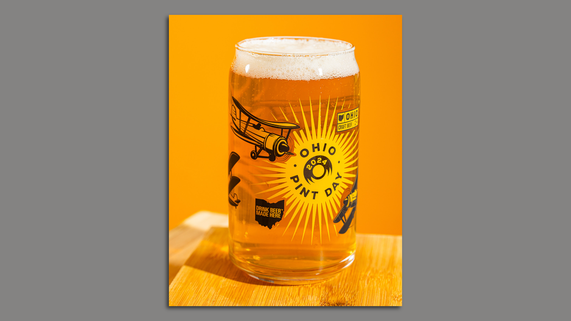 A pint glass of beer with Ohio design