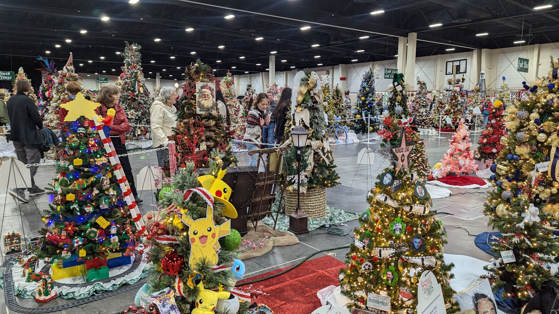 A room full of decorated christmas trees