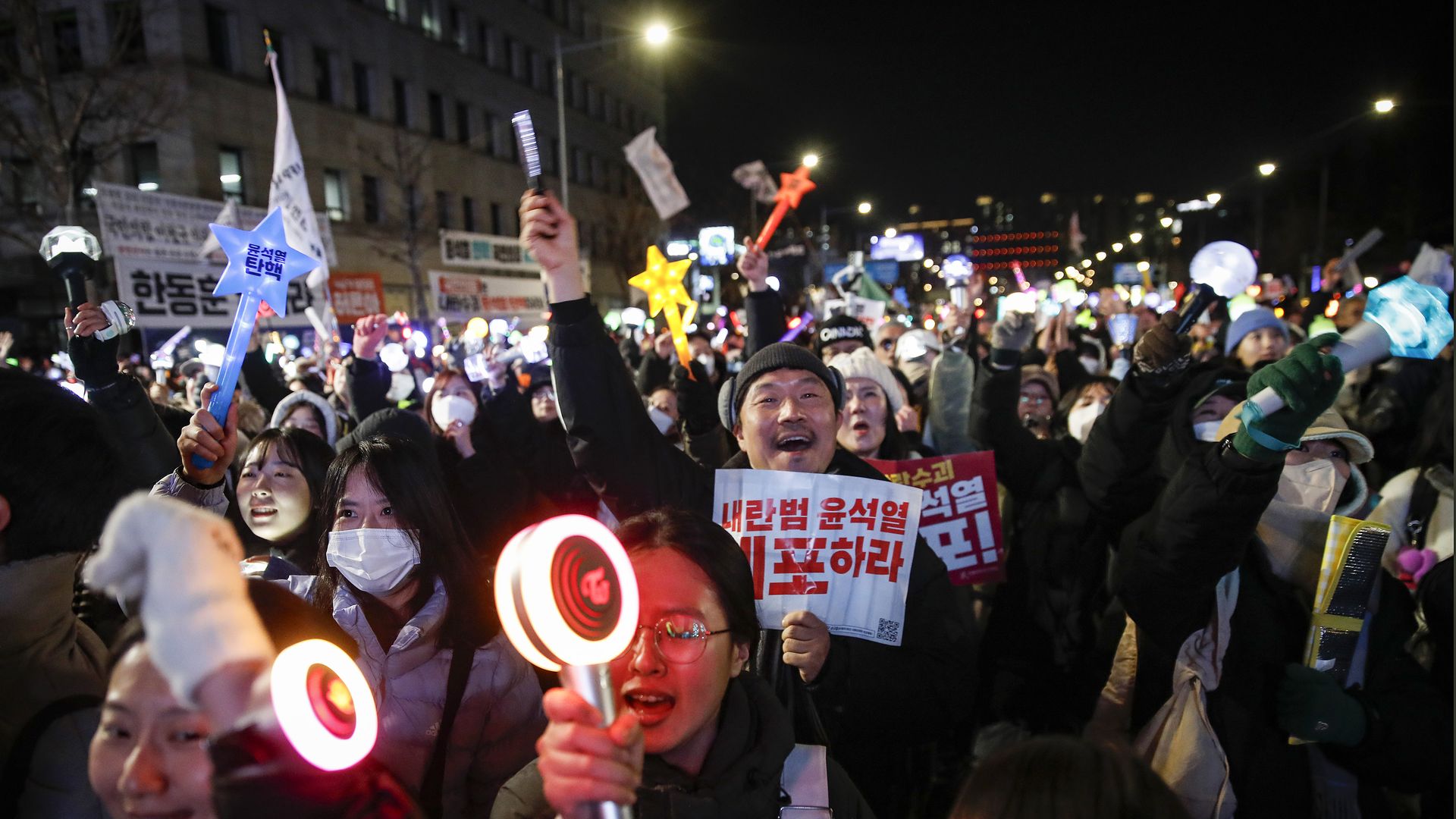 Protesters celebrate the impeachment of South Korean president Yoon Suk Yeol following his decision to impose a martial law, in front of National Assembly on December 14, 2024 in Seoul, South Korea.