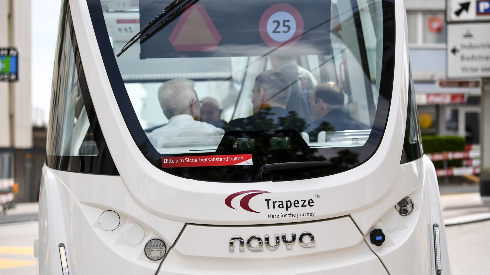 Christian Amsler and Winfried Kretschmann sit inside an autonomously driven bus of the Schaffhausen public transport during a test ride.