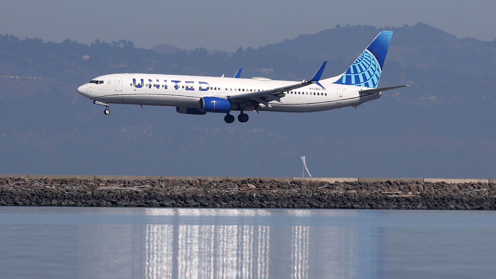 A United Airlines plane lands at San Francisco International Airport.