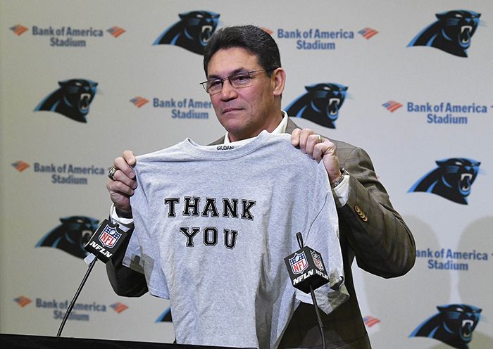 Former Carolina Panthers head coach Ron Rivera holds up a T-shirt at the end of a press conference at Bank of America Stadium in Charlotte, N.C. on Wednesday, Dec. 4, 2019. Rivera was fired as coach on Tuesday. 