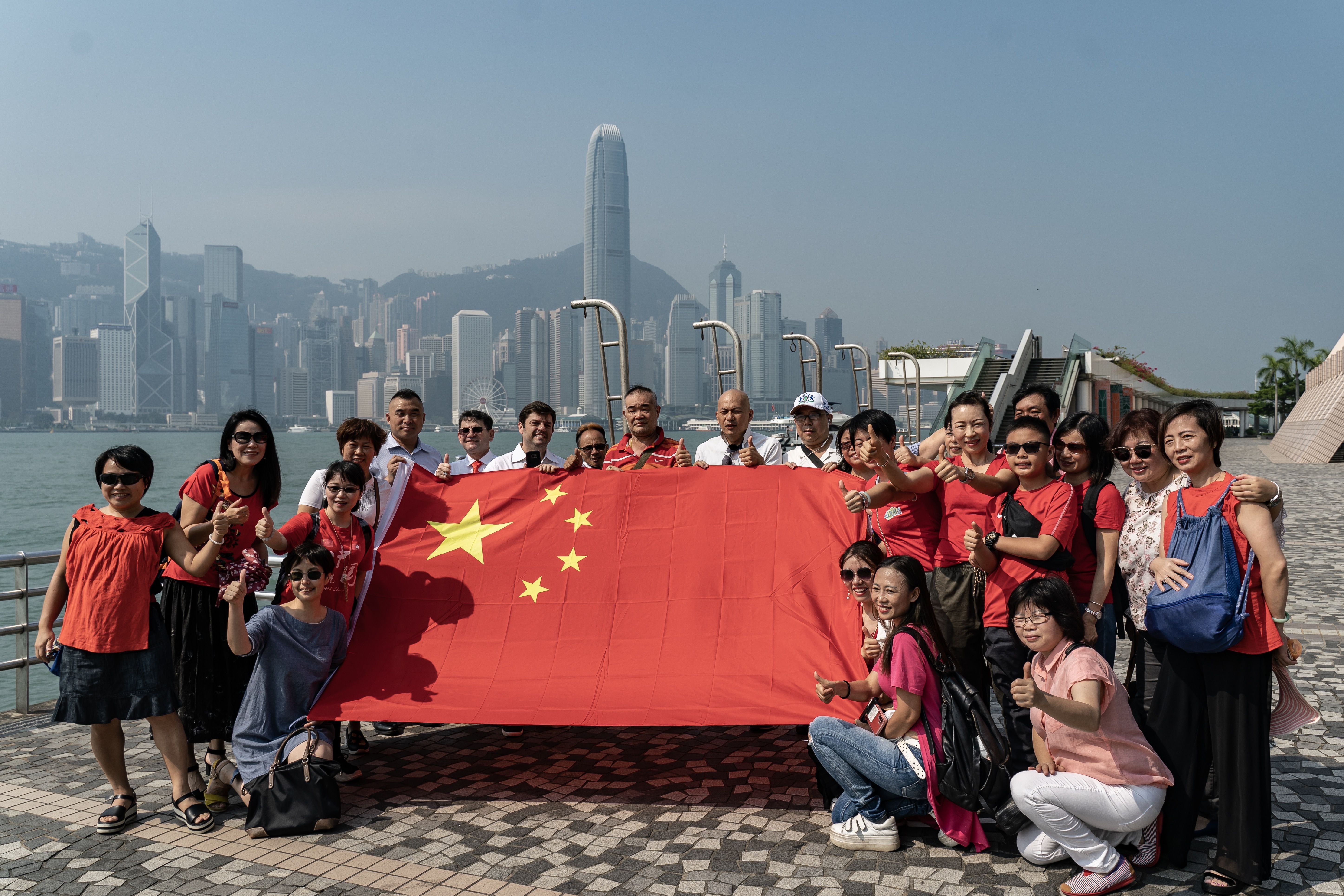 : Pro-China supporters wave Chinese flags during a rally at Hong Kong Cultural Centre on September 29, 2019 in Hong Kong
