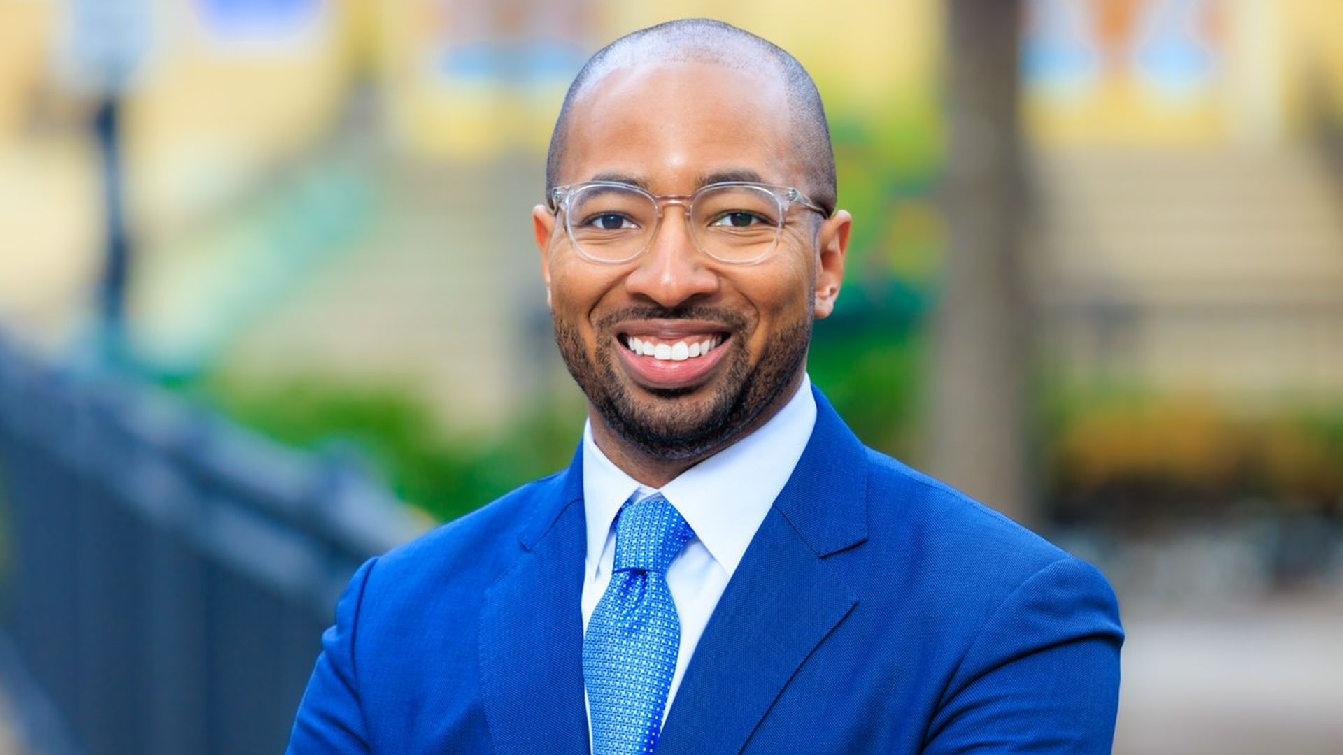 Photo of a man in a suit posing.
