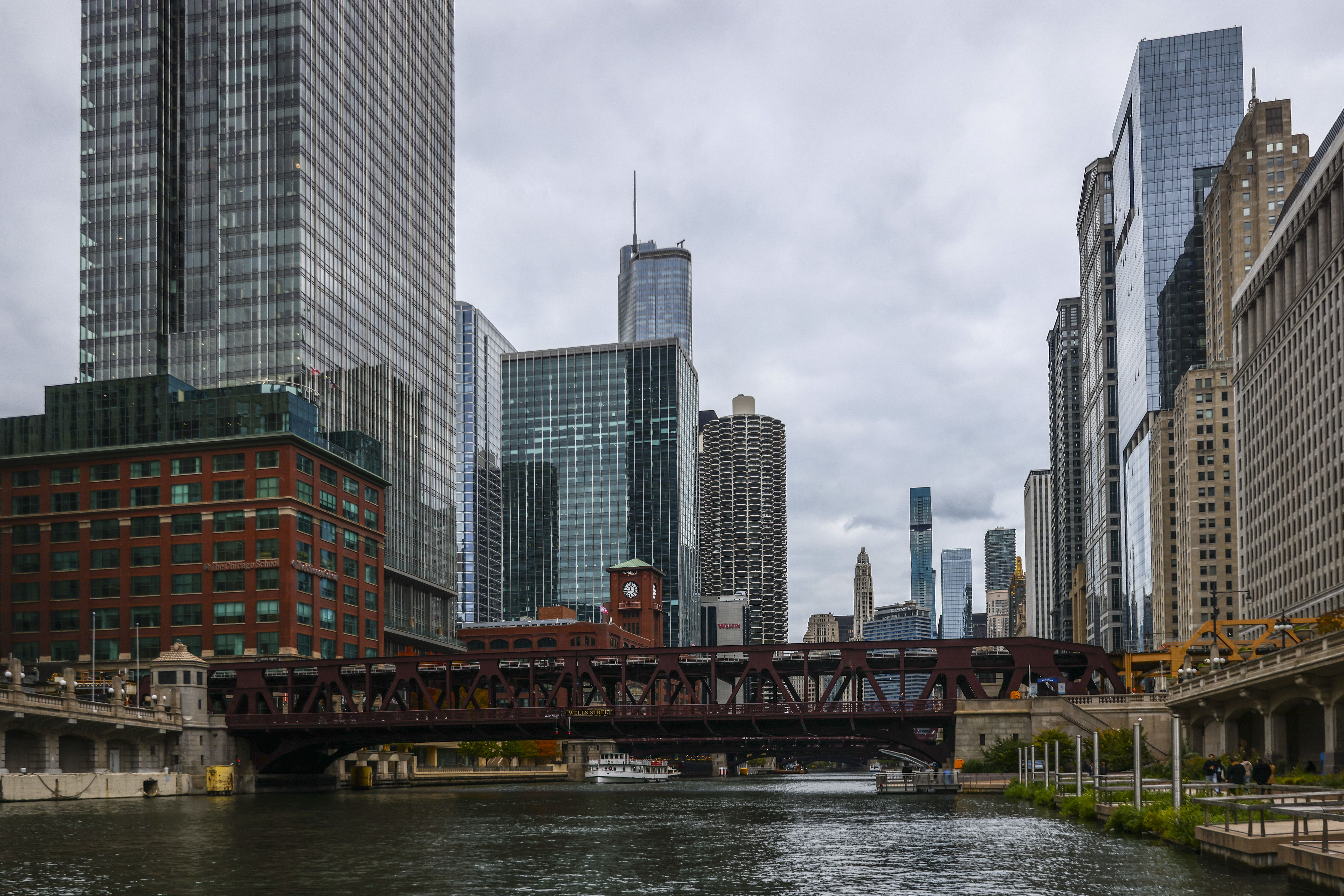 Photo of a river with skyscrapers surrounding it. 