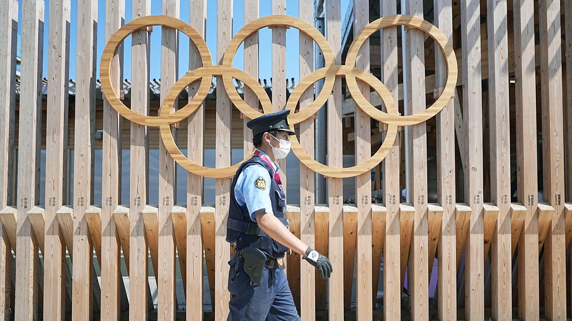  A police officer walks past Olympic rings at the entrance to Olympic Village in Tokyo, Japan, on Monday.