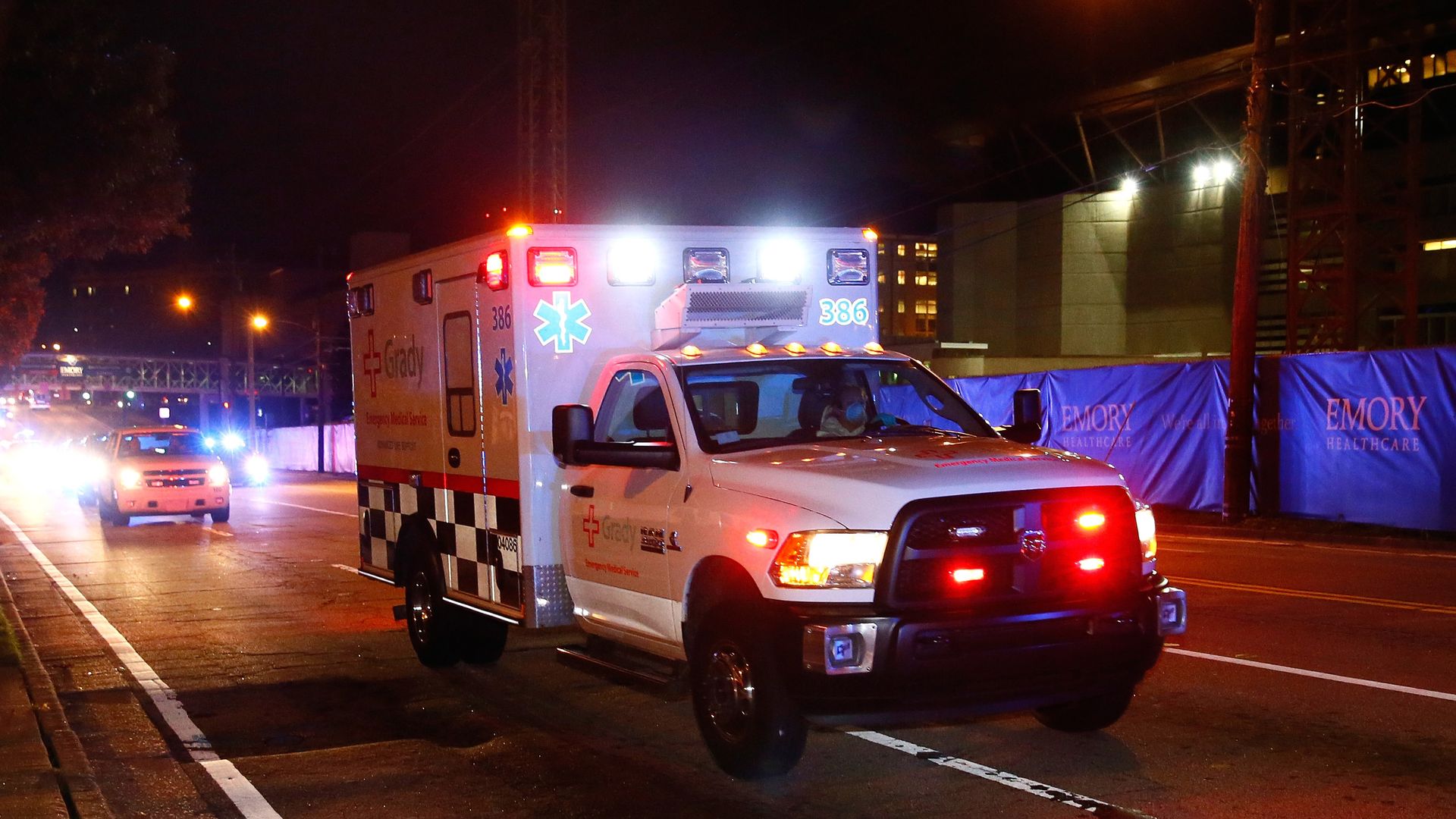 An ambulance with lights flashing.
