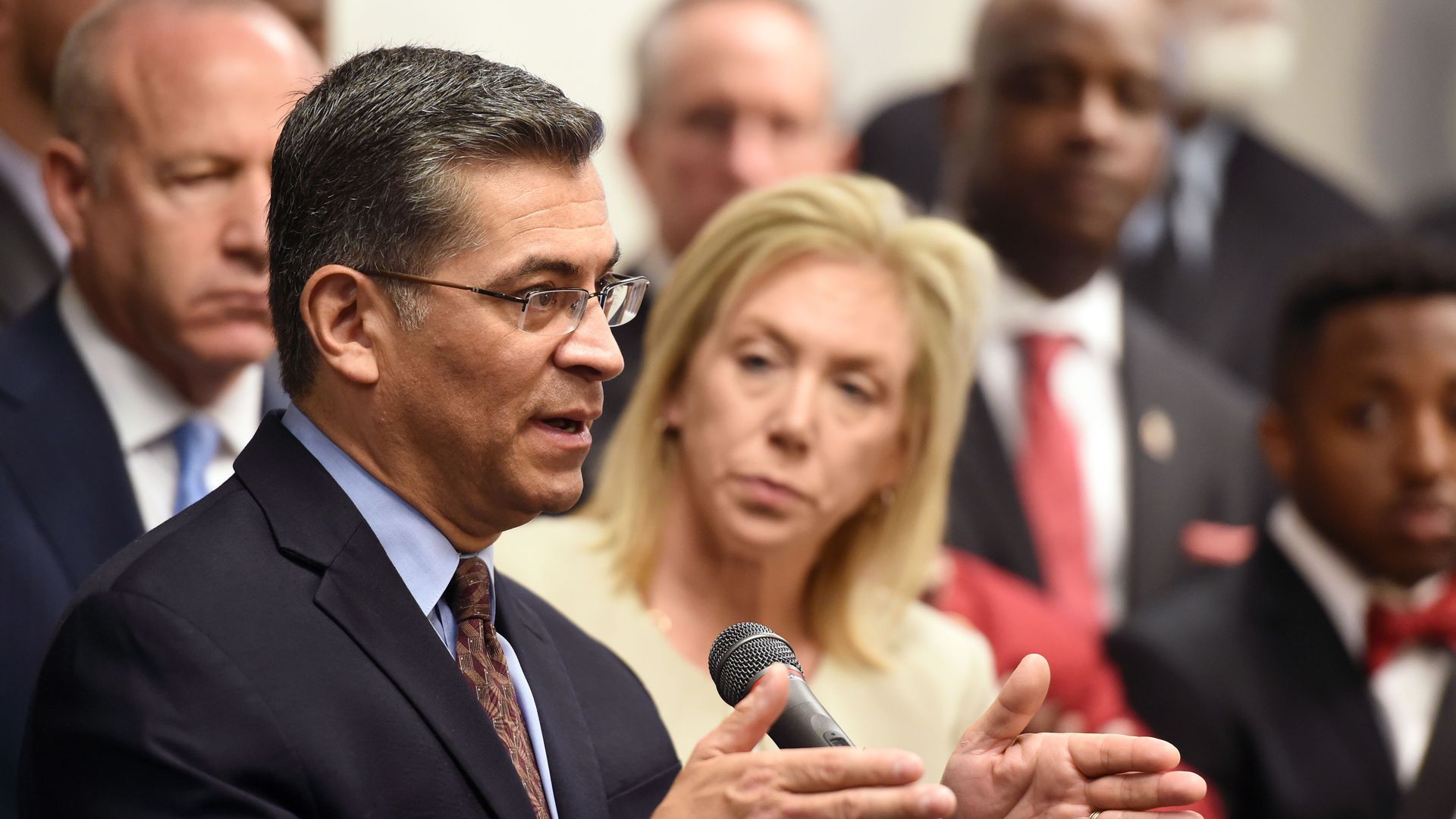 Xavier Becerra speaking at a press conference.