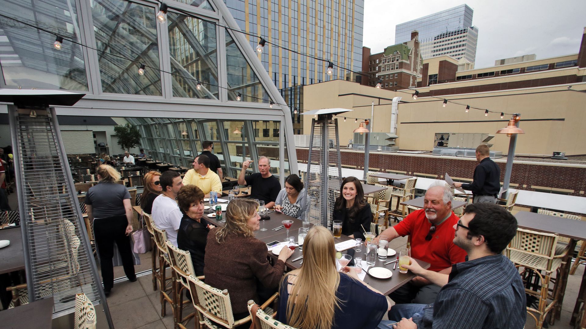 People dine and drink on a rooftop
