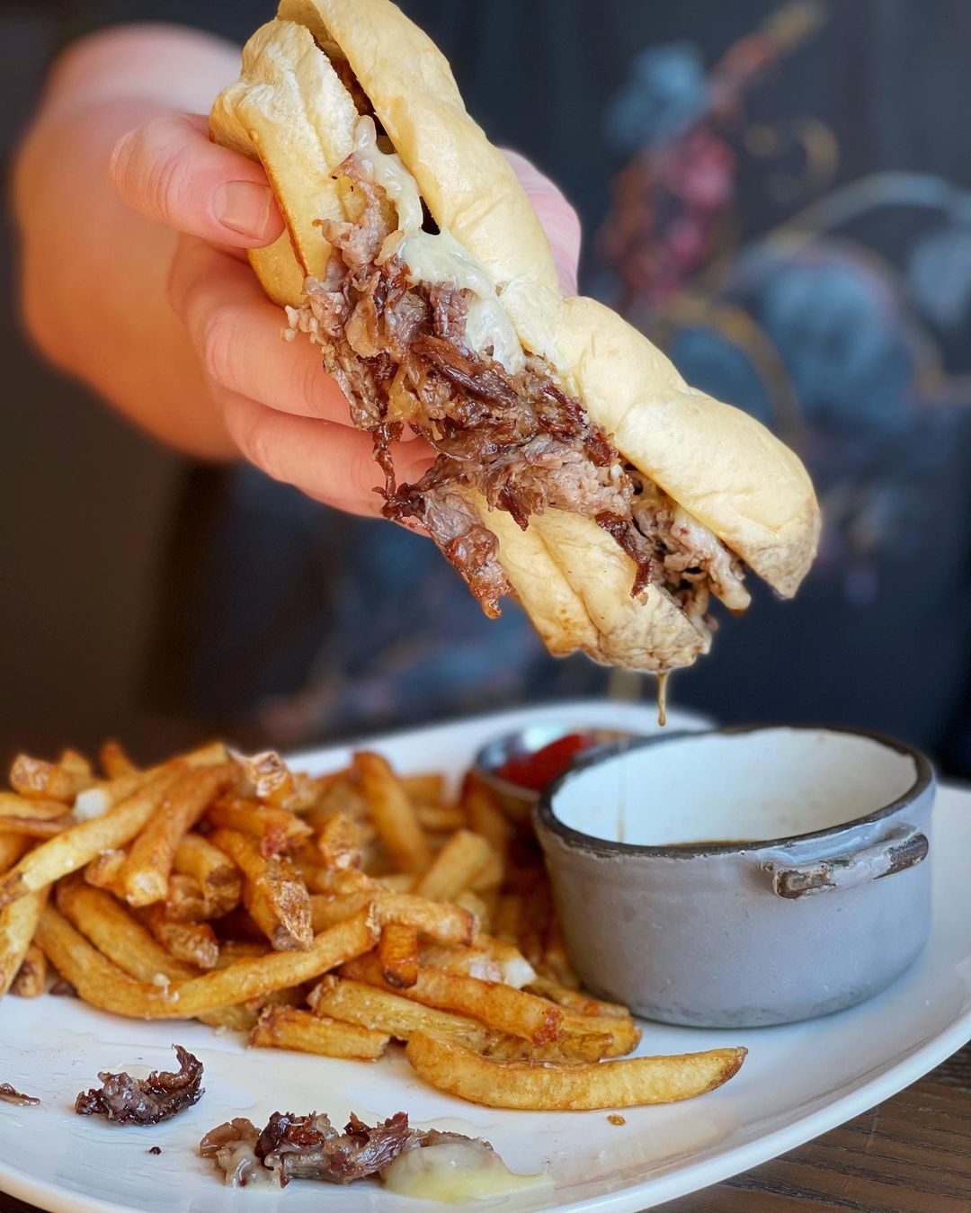 Shaved Ribeye Sandwich and French Fries at Earnest Bar & Hideaway in Nashville, TN
