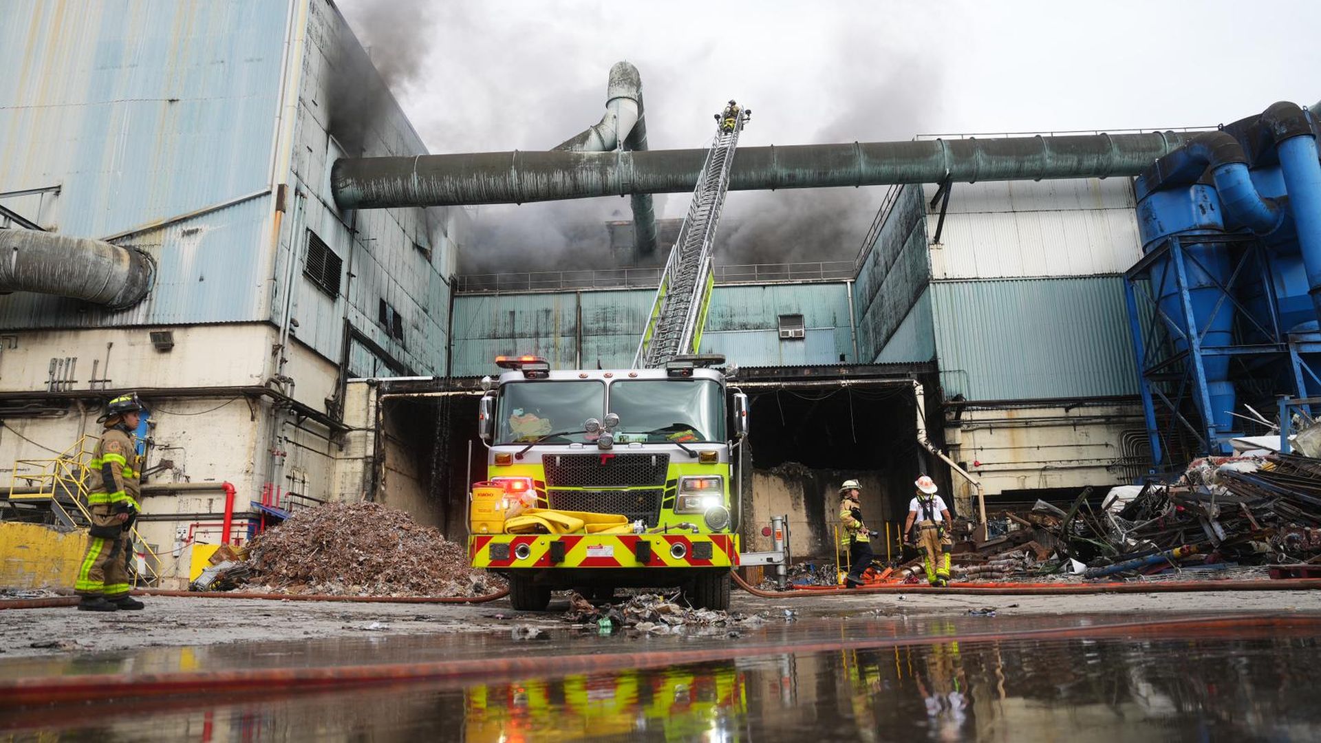 Firefighters work to put out a fire at a trash incinerator plant in Doral.