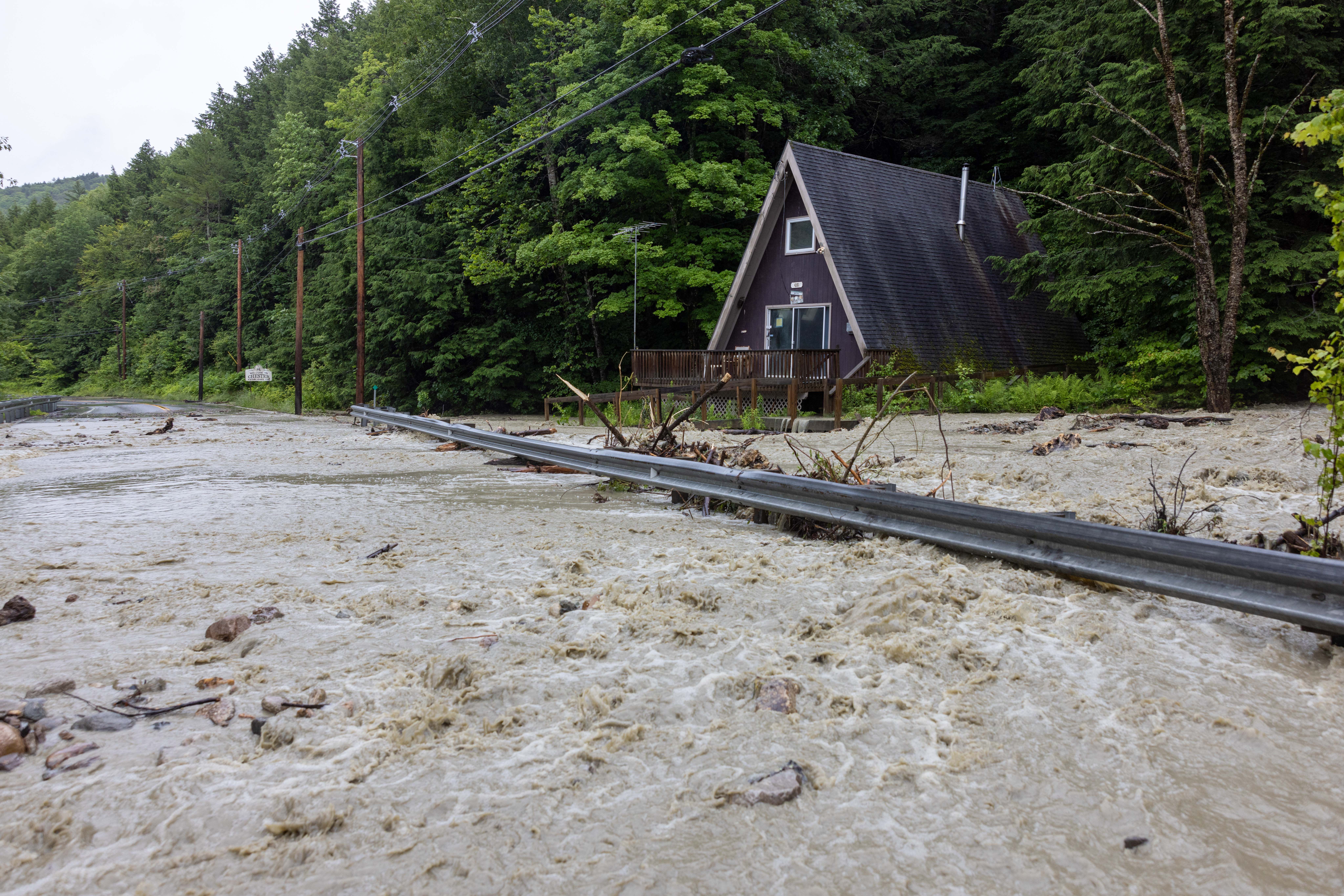 Water floods around a house on Route 11 on July 10, 2023 in Windham, Vermont. 