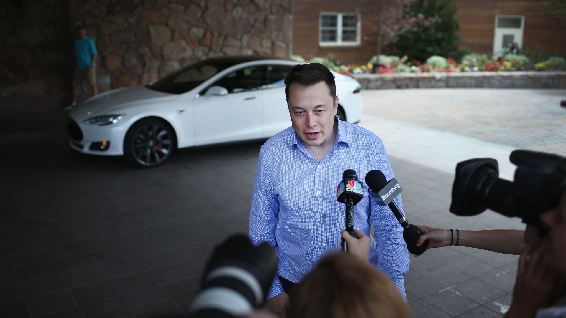 Elon Musk speaking to reporters.