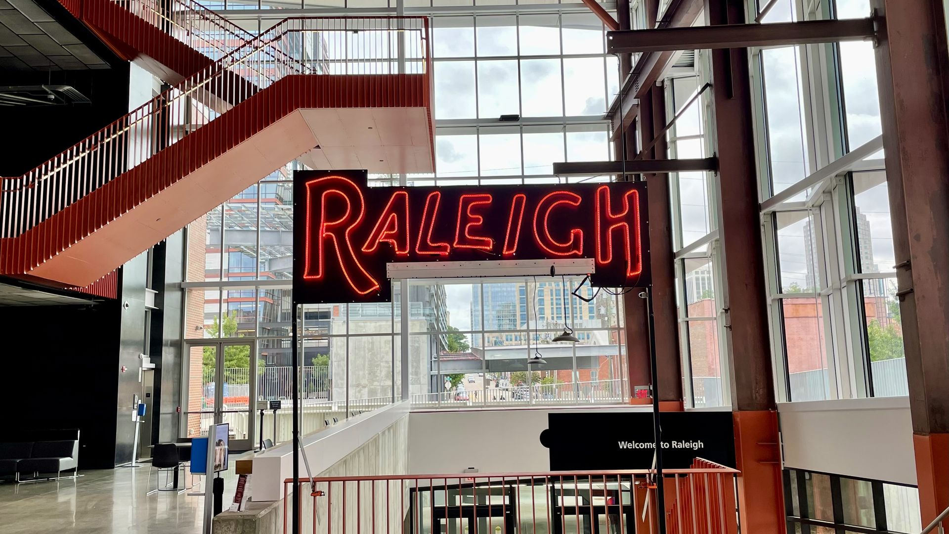 A neon sign that reads Raleigh. 