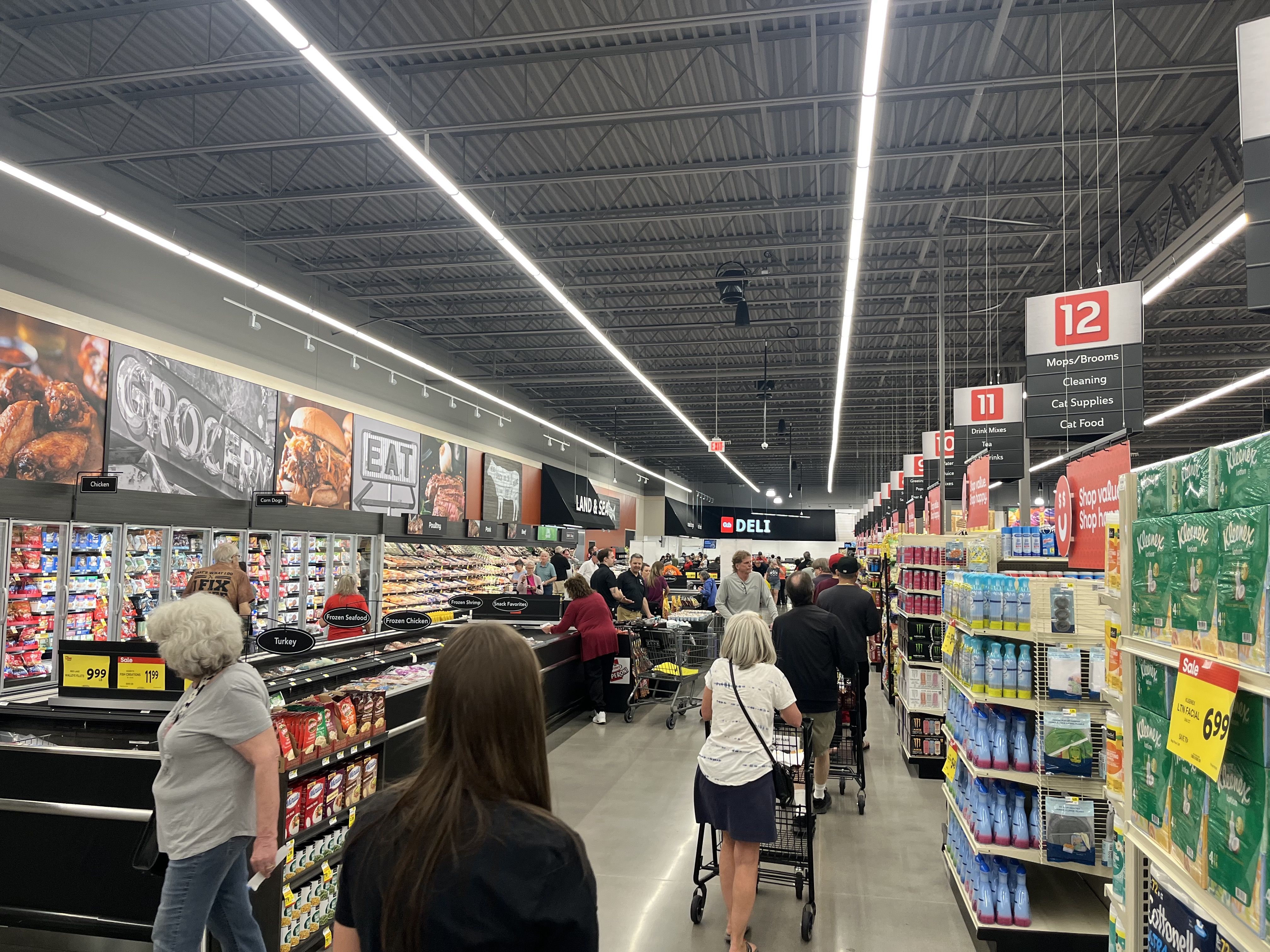 A photo of people shopping in the meat aisles at Cub Foods 