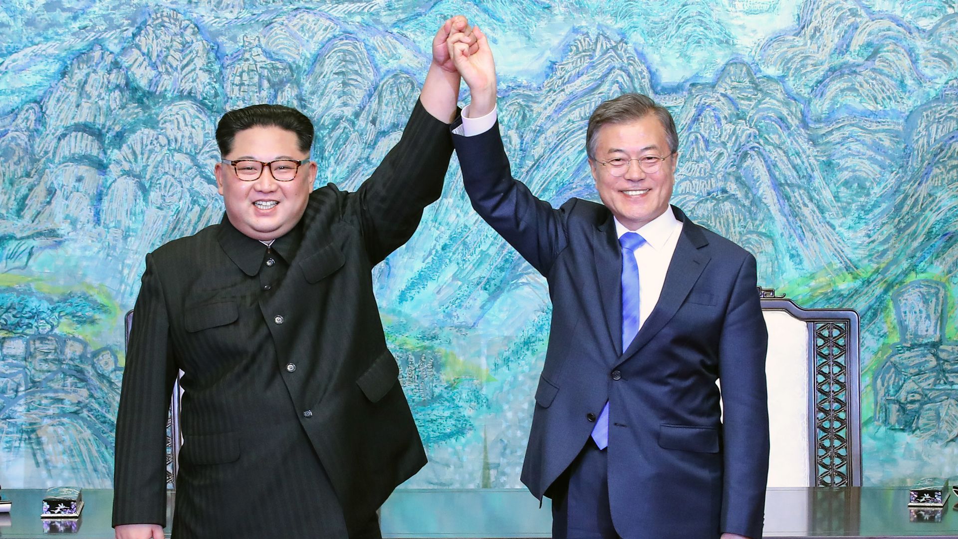 Kim Jong-un and Moon Jae-in holding hands at their summit
