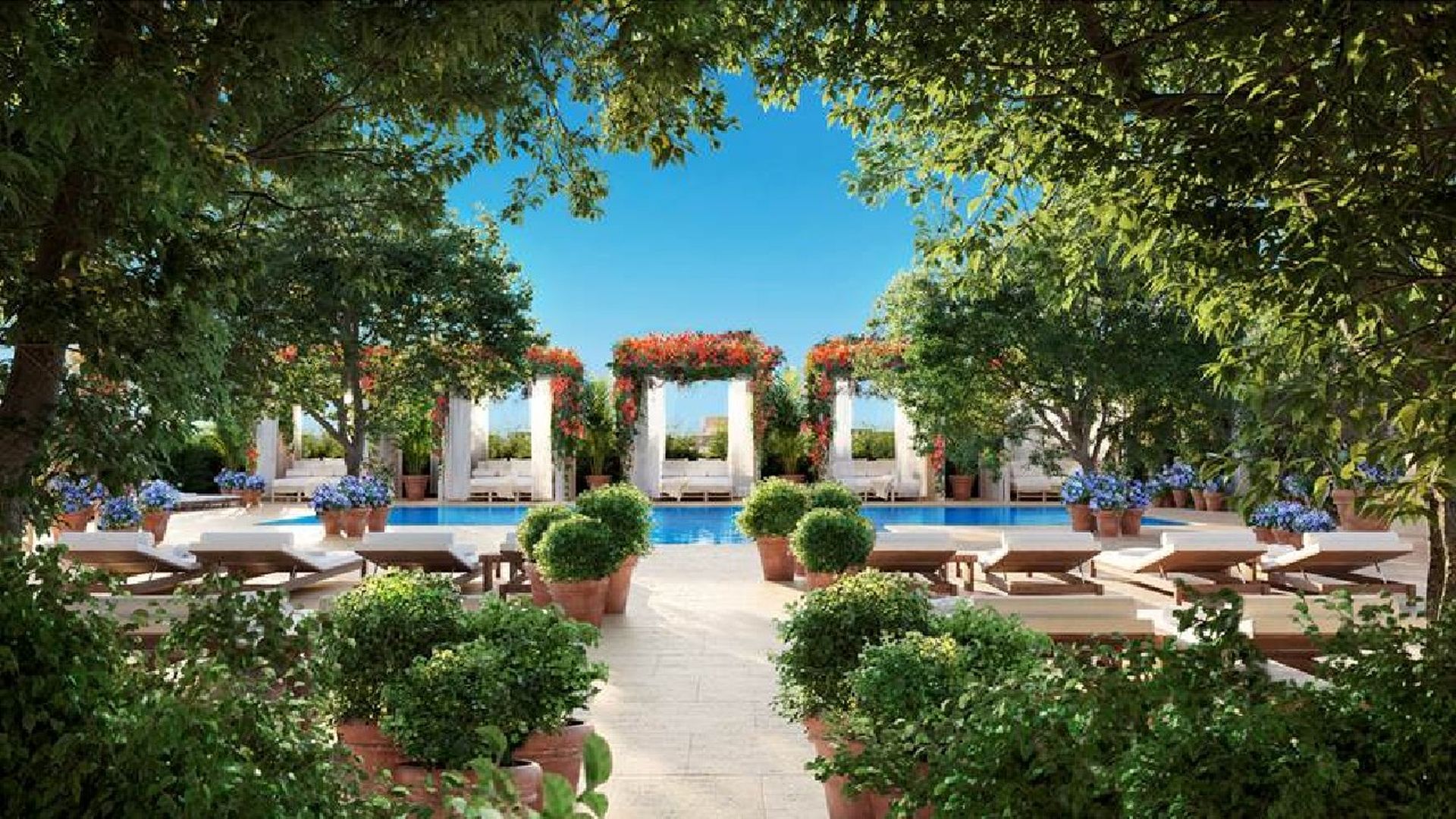 A view of the swimming pool and gardens at Edition