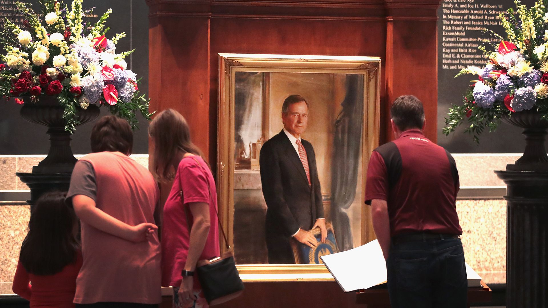 Visitors sign a guest book at the George H.W. Bush Presidential Library Center in College Station, Texas. 