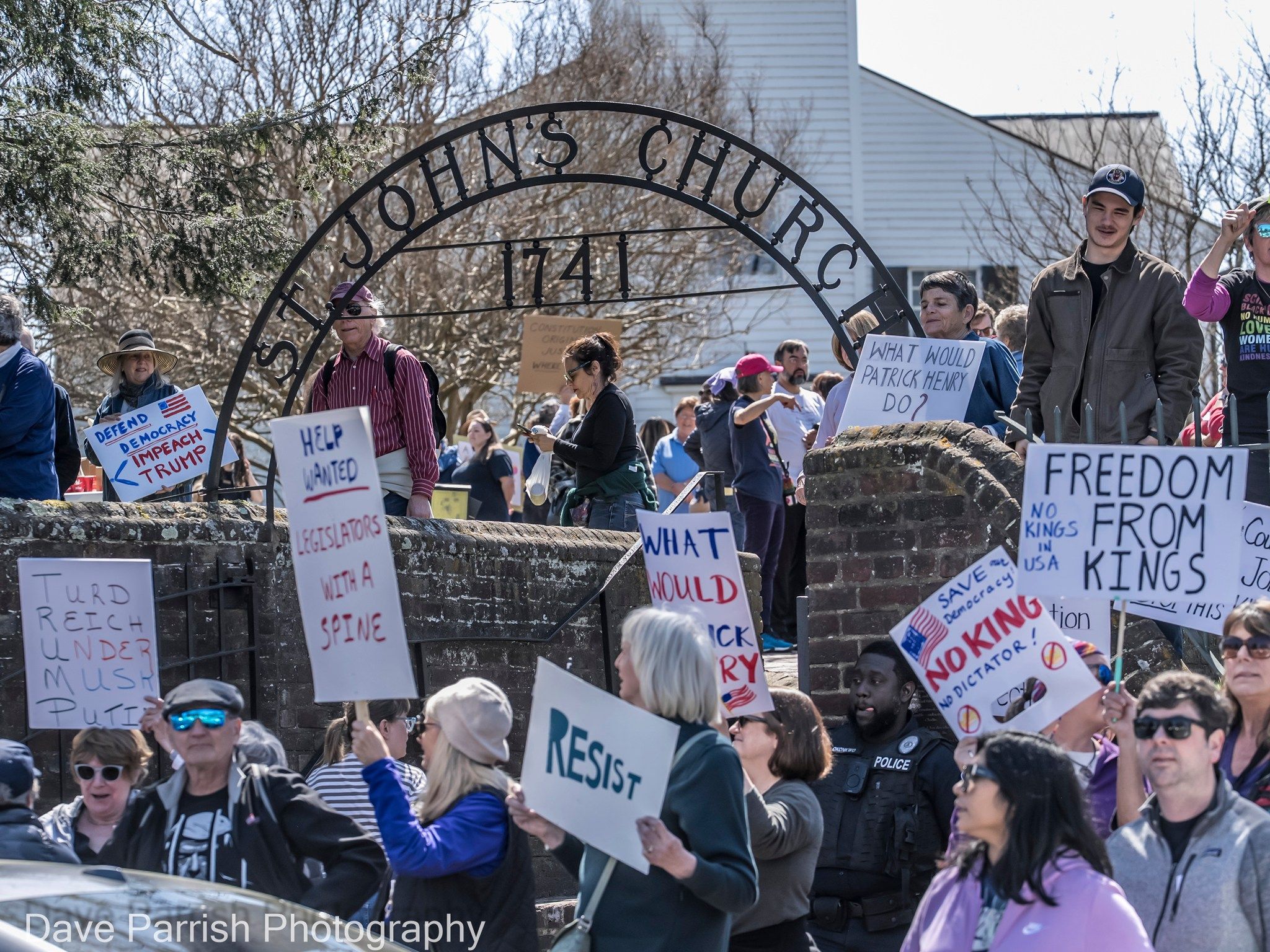 a bunch of people protesting outside of a church 