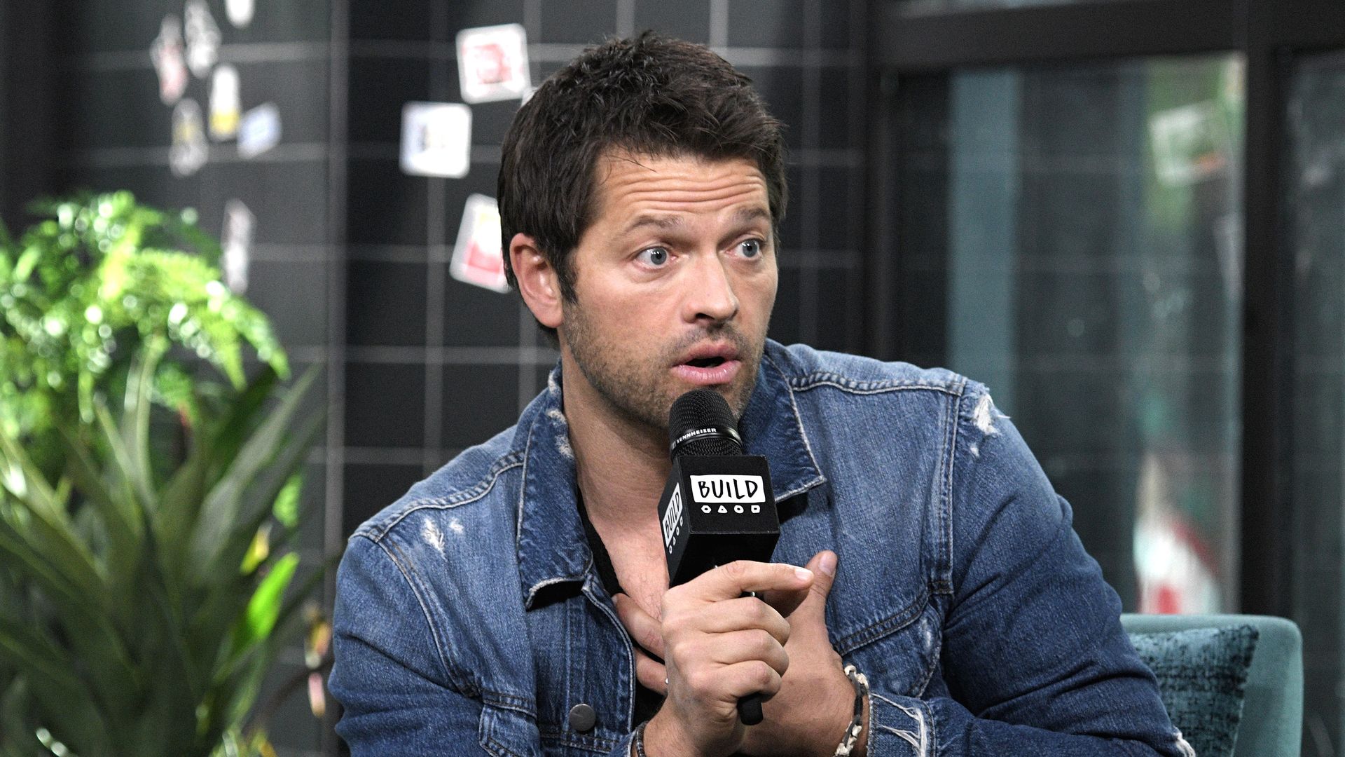 Actor Misha Collins speaks into a microphone