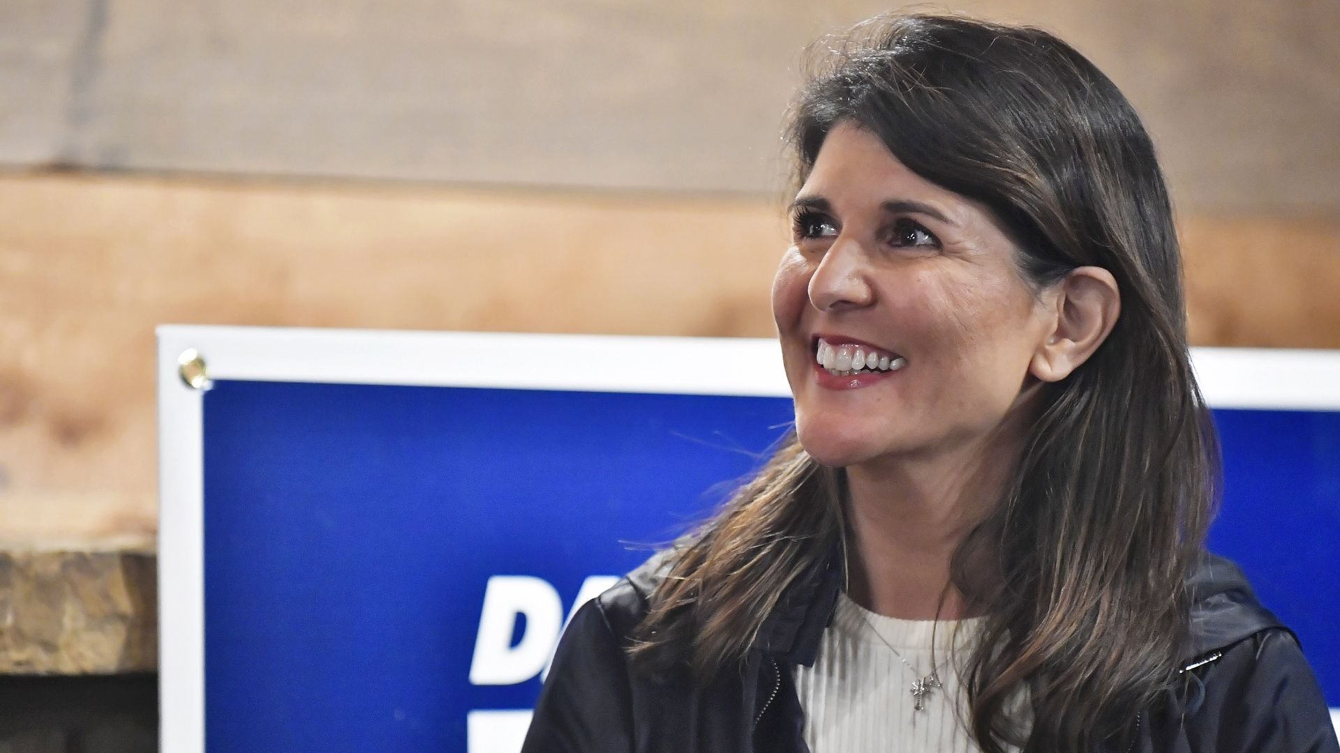 Nikki Haley smiles while looking to the left