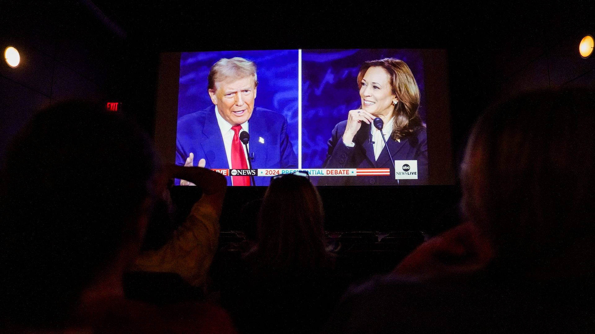 Former US President Donald Trump and US Vice President Kamala Harris are shown on screen during a debate watch party at the Cameo Art House Theatre in Fayetteville, North Carolina, US, on Tuesday, Sept. 10, 2024. 