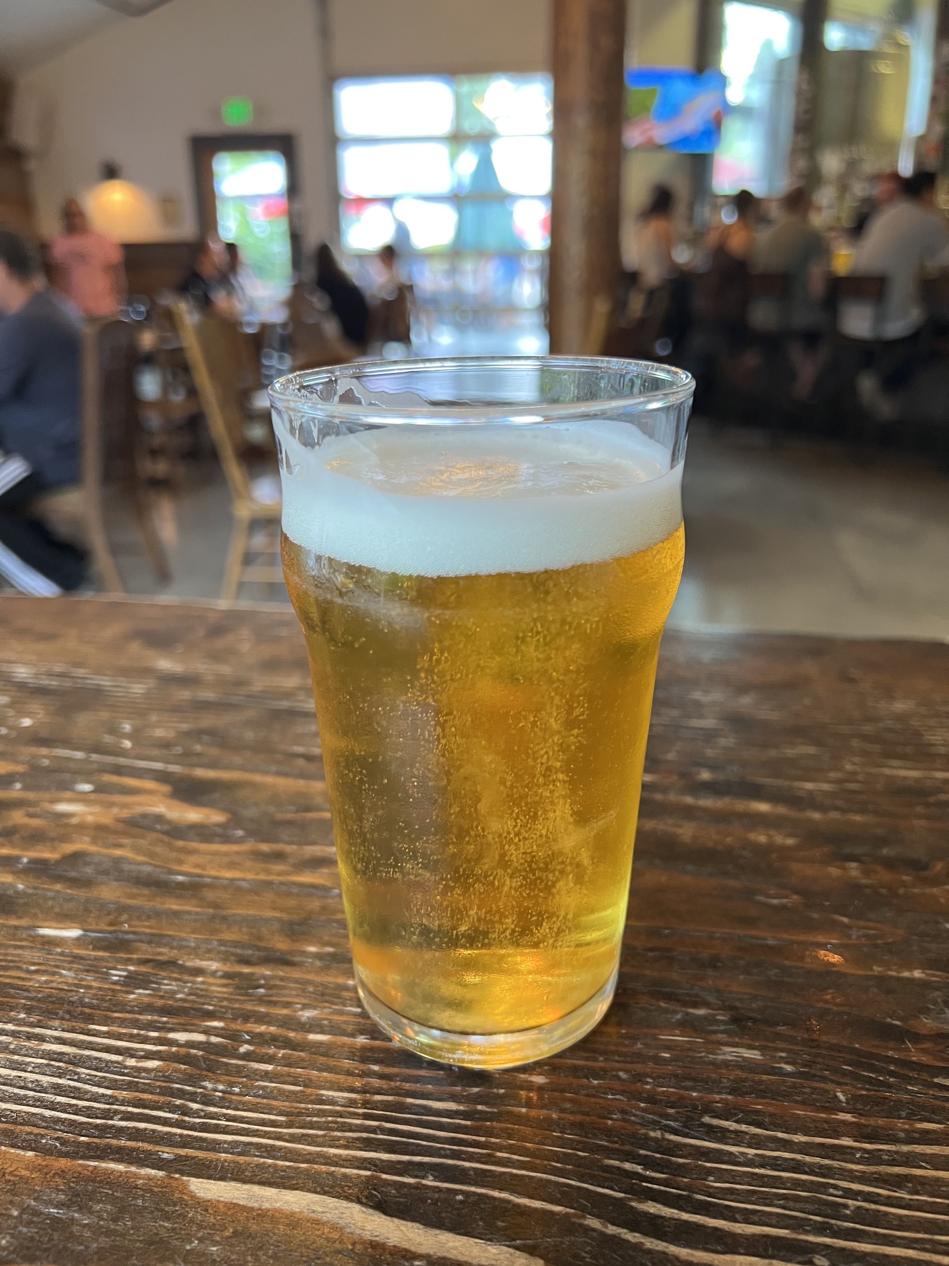 A photo of a pint glass full of beer.