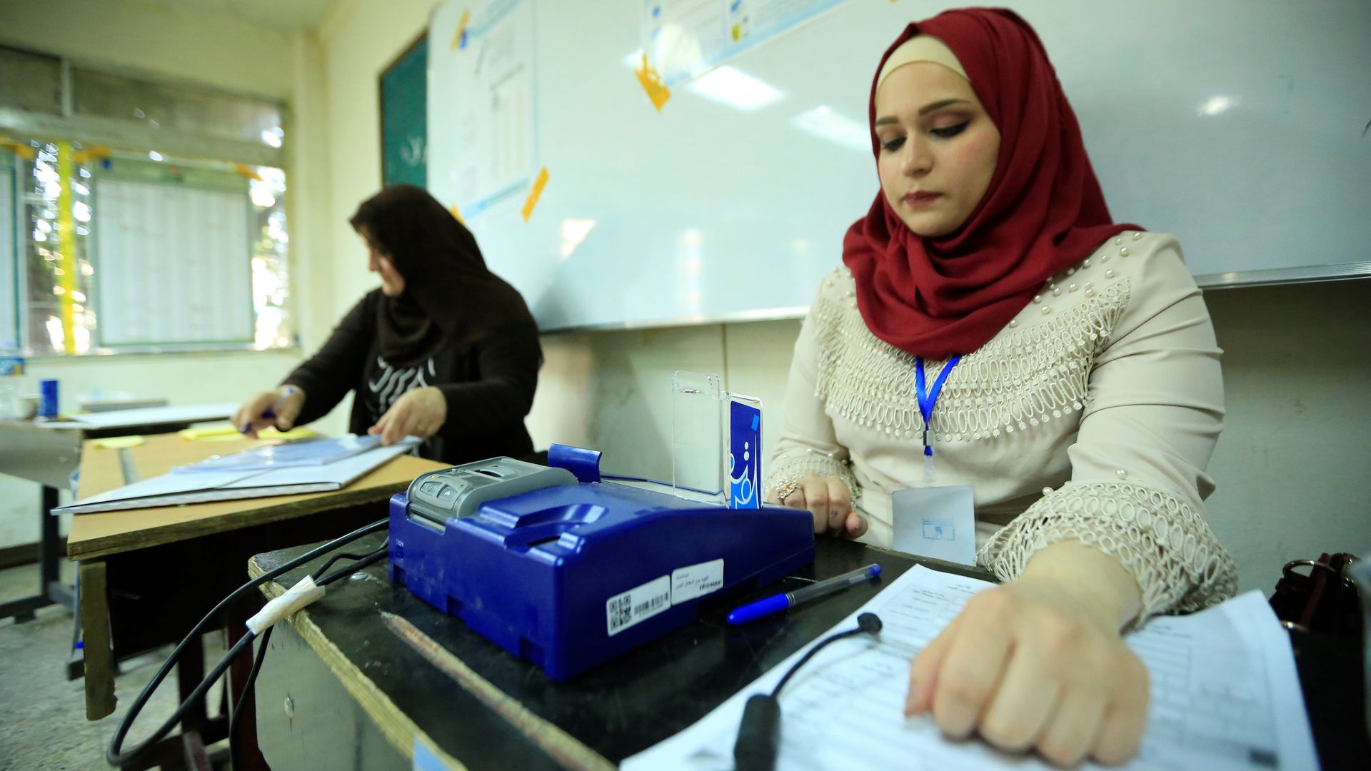 Poll workers in Baghdad