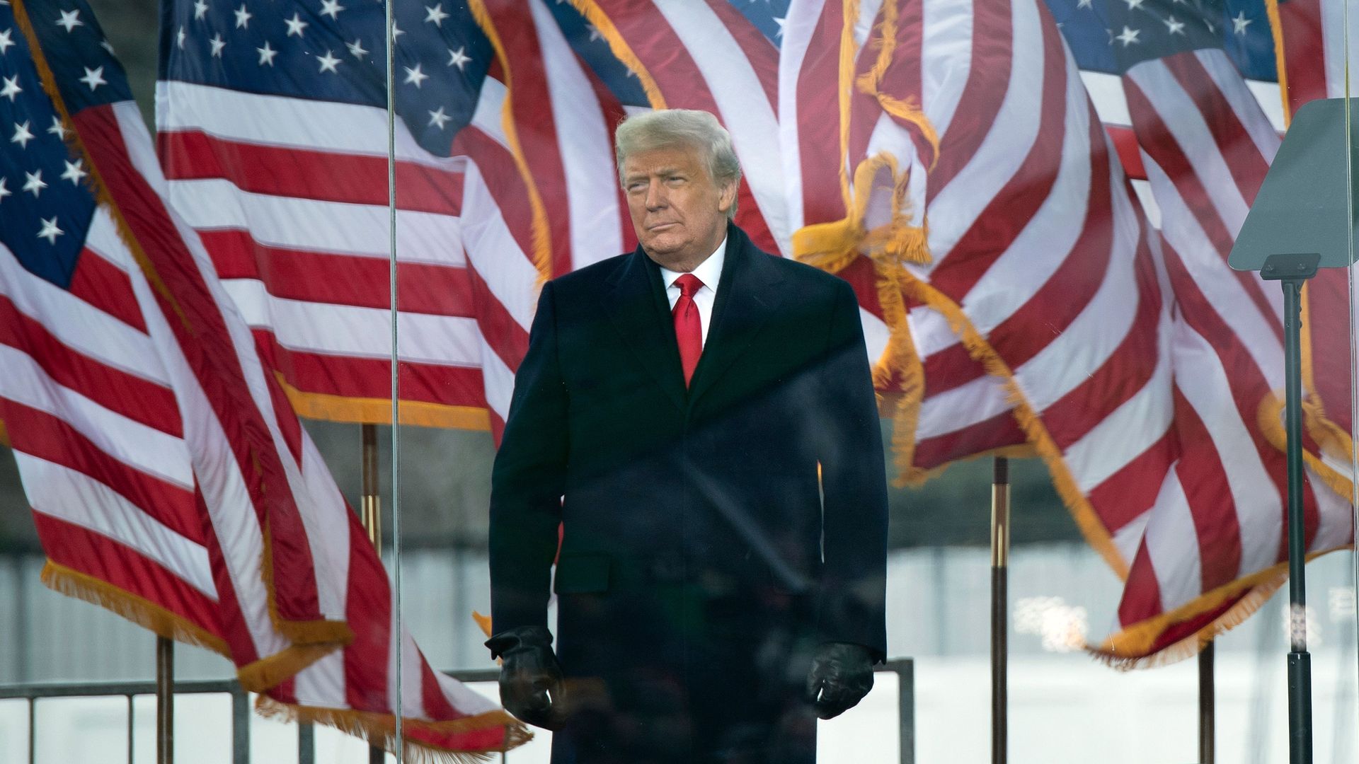 Trump standing on a podium.