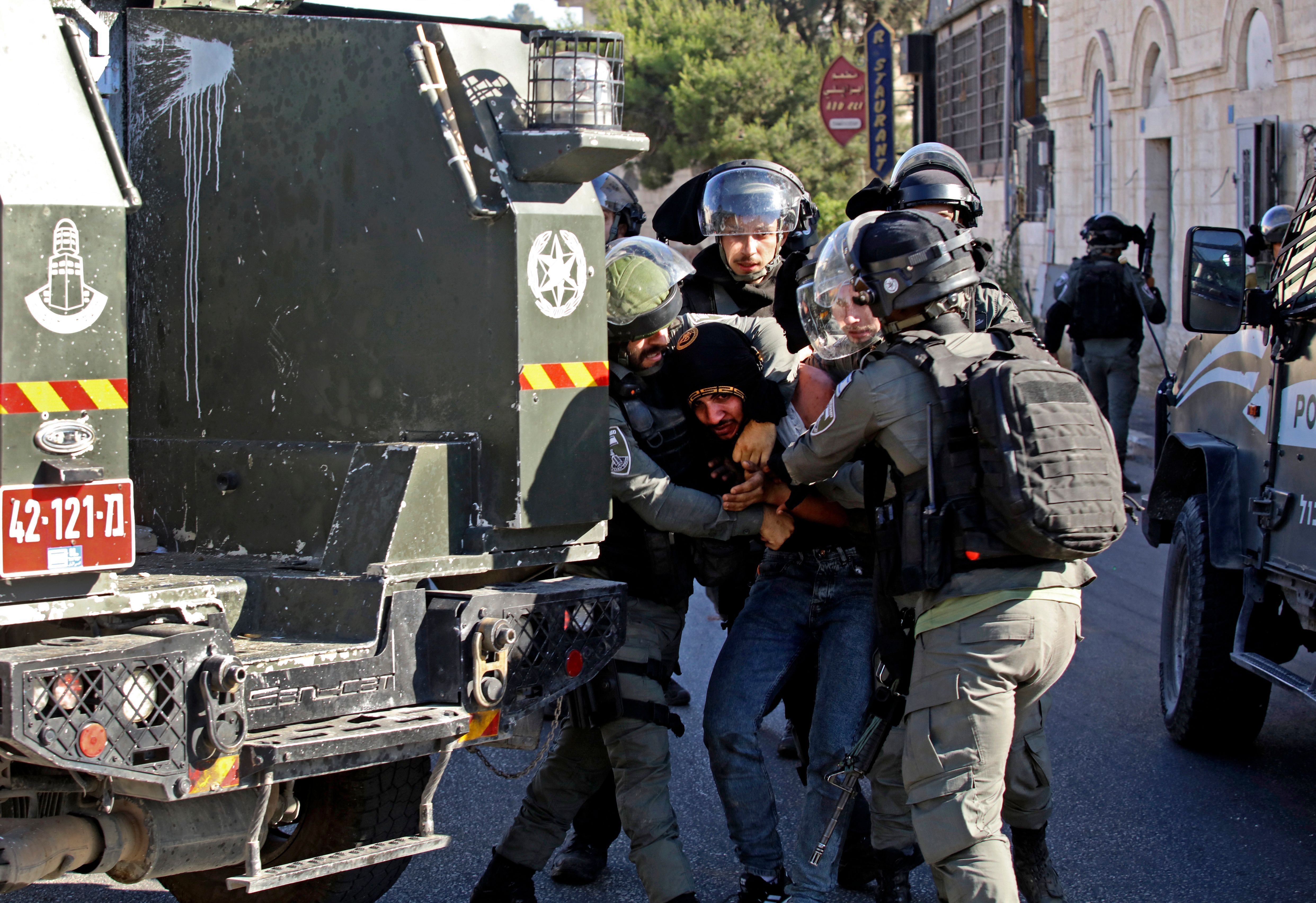 Israeli soldiers restrain a Palestinian protester in Bethlehem. 