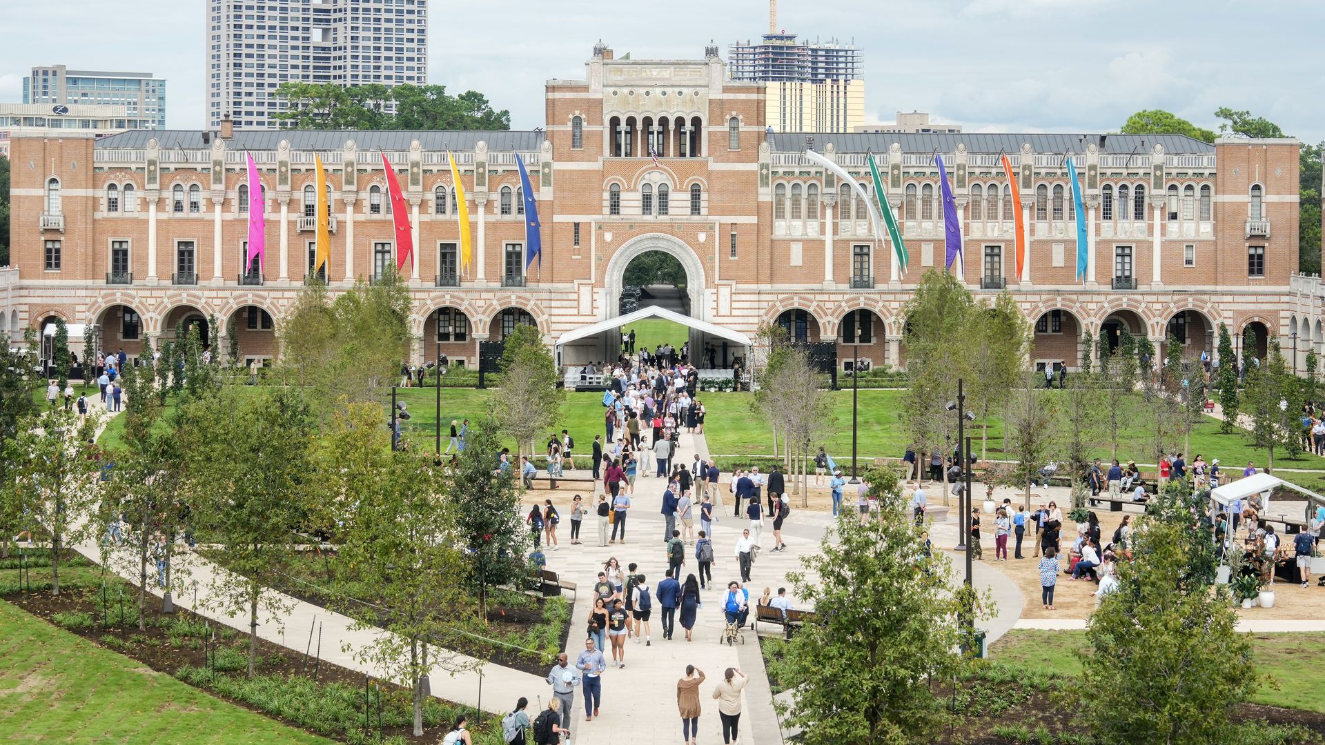 Photo of the Rice University campus with people walking around. 